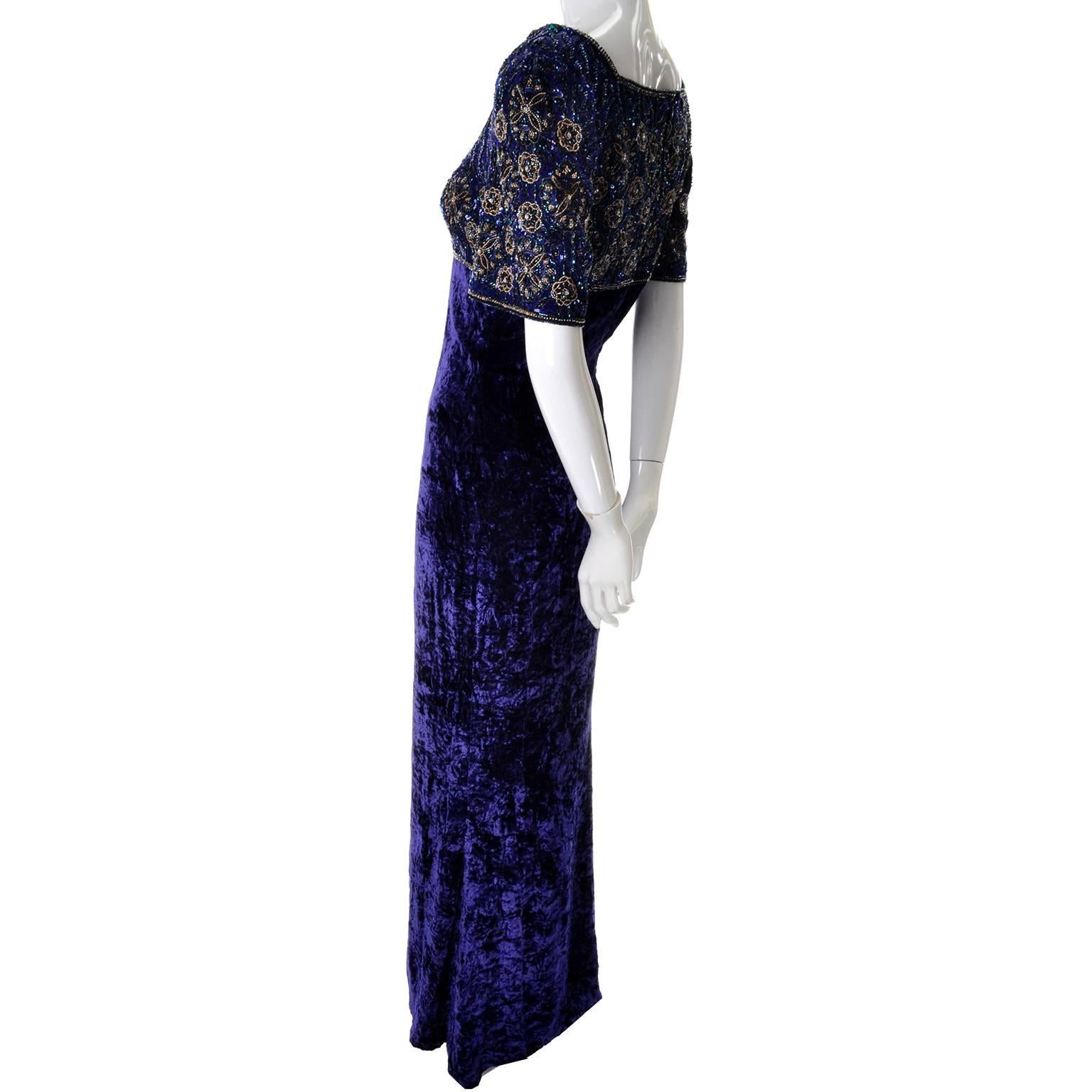 This beautiful blue vintage Escada Couture evening gown has a beaded bodice with beads and sequins creating a radial floral designs across the front, back and sleeves. This dress has an umpire waist and square neckline, and the entire dress is