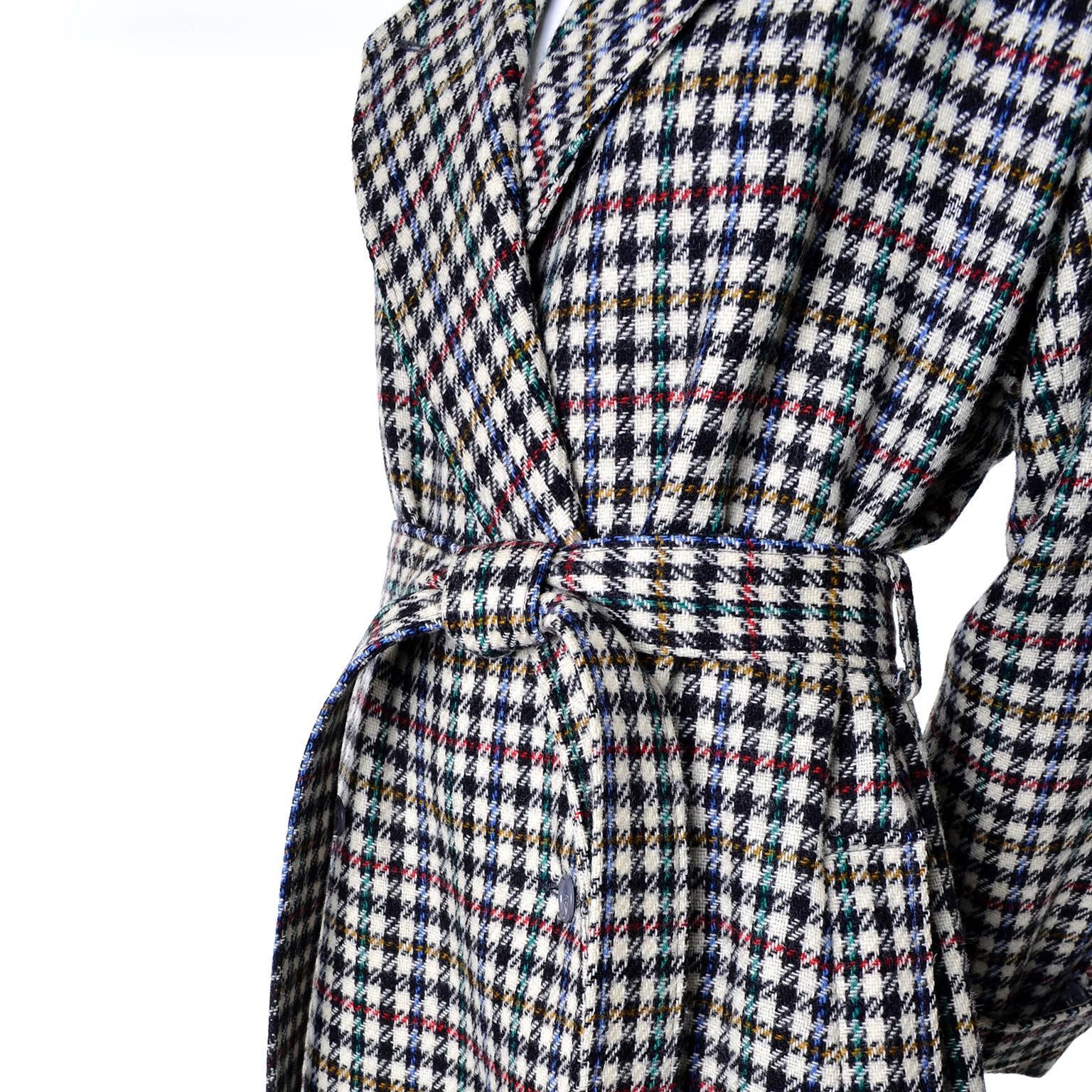 This fabulous vintage coat was designed by Kenzo in the 1980's.  The coat is 100% wool in a modern black, white, red, gold and green houndstooth plaid. The coat has pockets, a fabric belt, and is fully lined in a 70% wool 30% nylon blend. There are