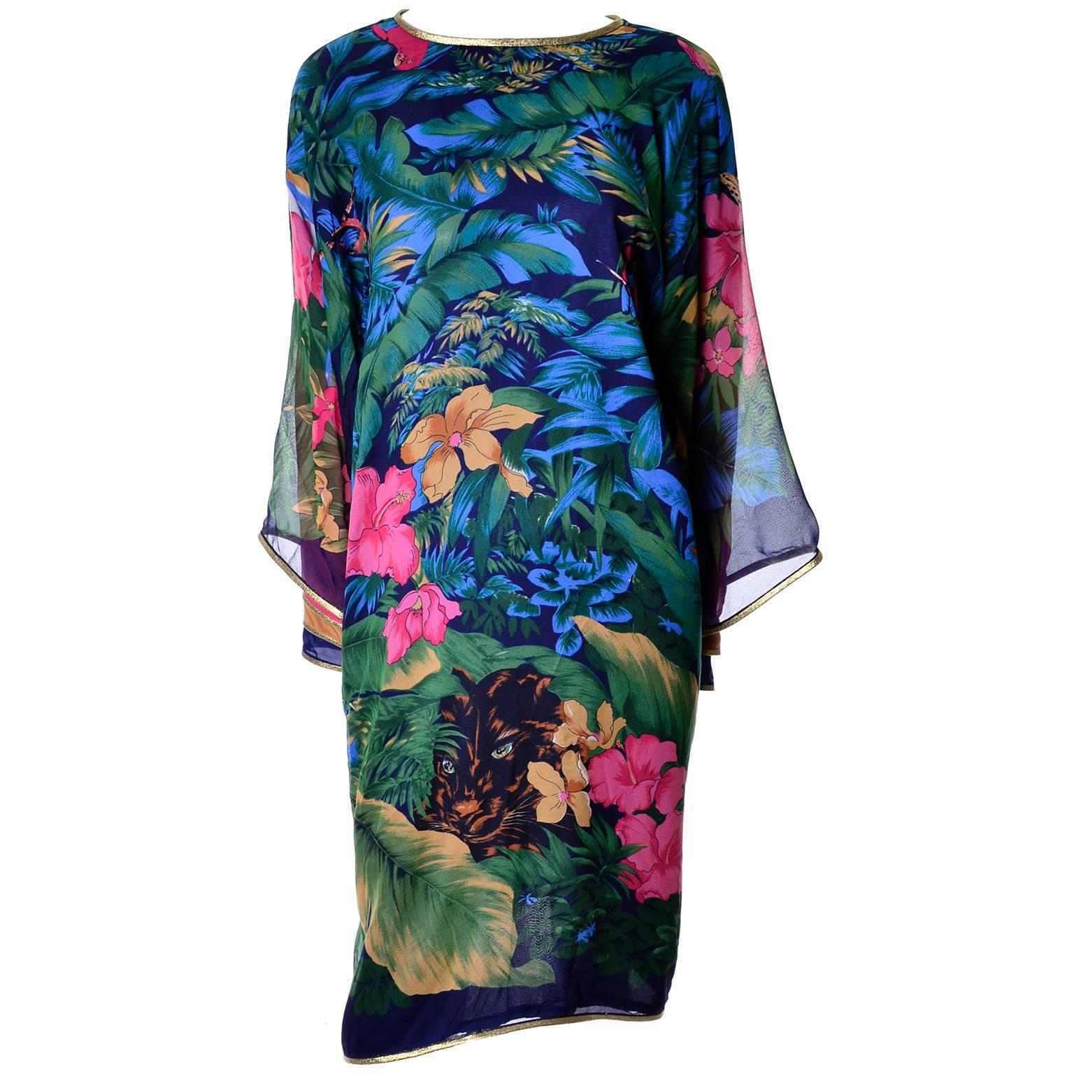 This is an outstanding vintage caftan style dress in a beautiful silk chiffon floral print with navy blue lining.  The dress ties at the back of the neck with gold ties that have jeweled tassels on the ends and the back is somewhat open to the