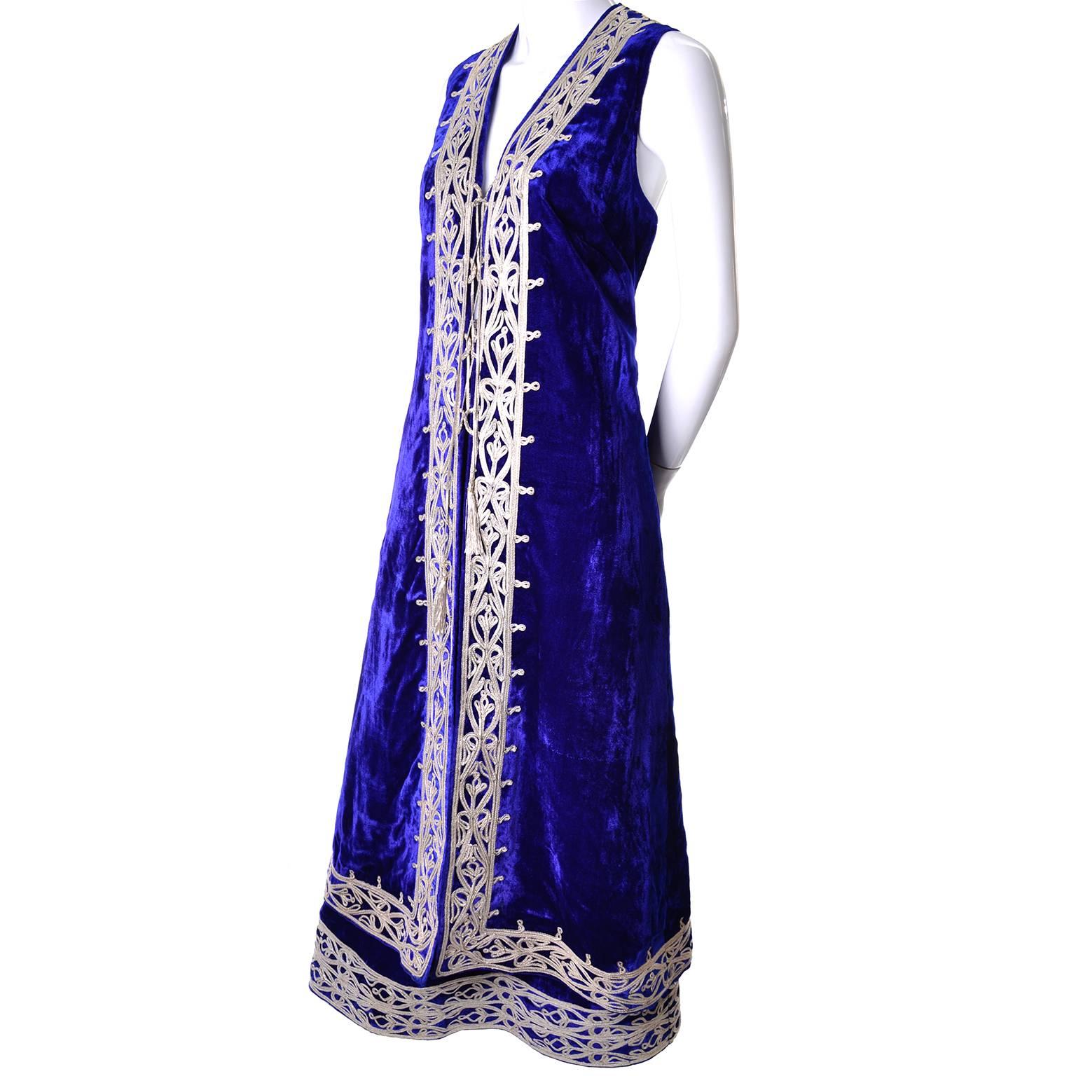 This is an outstanding royal blue velvet 2 piece vintage Afghan skirt and sleeveless waistcoat or vest outfit. The outfit has Pashtun style silvery gold braid embroidery that wraps around the waist and the hem of the skirt. The skirt and top are