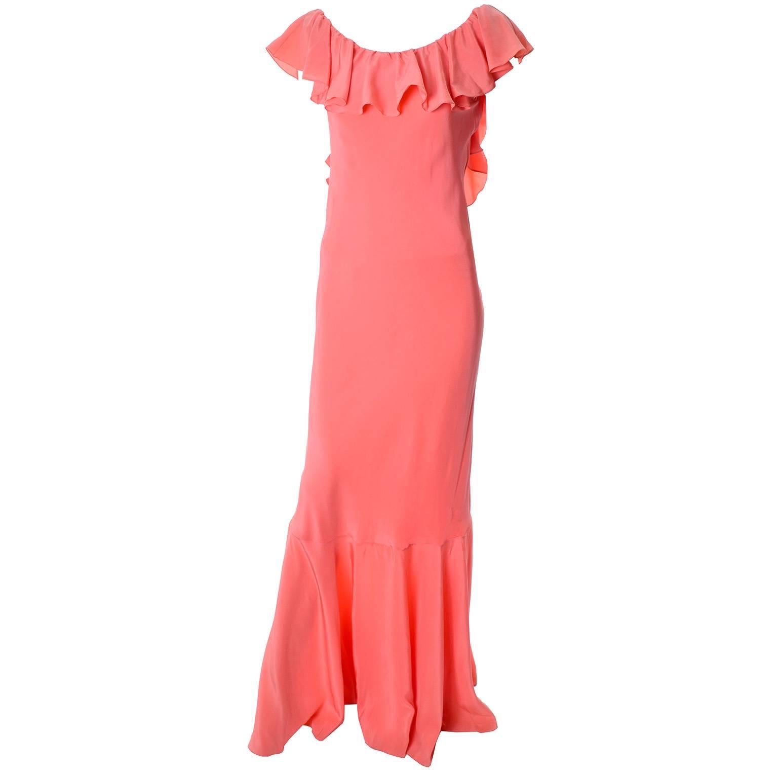 New vintage salmon silk vintage long dress by Oscar de la Renta with the original tags. This beautiful dress was purchased at Dorcas Hardin in Georgetown, DC. in the 1990's. The dress has a gorgeous ruffled neckline that plunges down the back and a