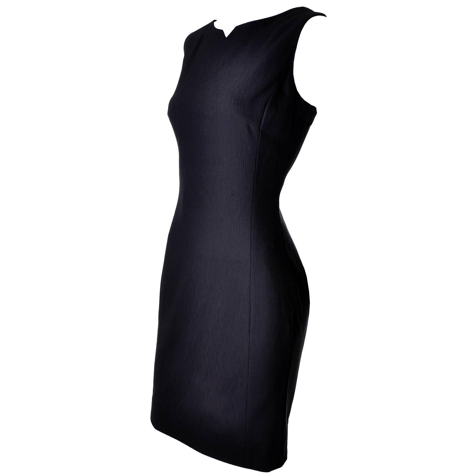This beautiful dress suit includes a sleeveless black Escada dress and a matching jacket. The slim fitting dress has a notched neckline and zips up the back. The blazer has subtle shoulder pads and logo marked buttons up the front and on the cuffs.