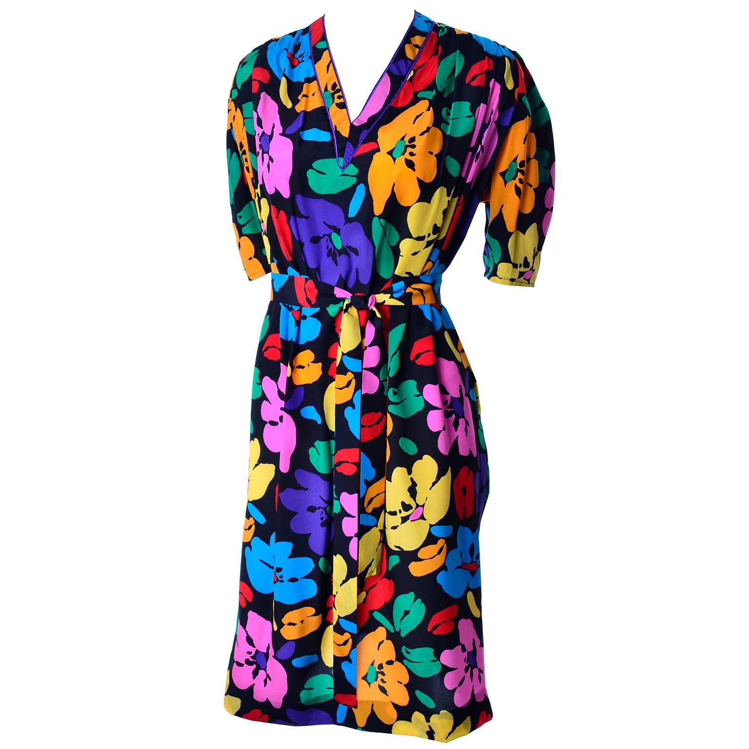 This Emaunel Ungaro Parallele dress is in a wonderful bright bold floral silk print. The dress fits very loosely and can be worn with or without its fabric tie. The beautiful floral print has shades of purple, red, blue, yellow and orange flowers