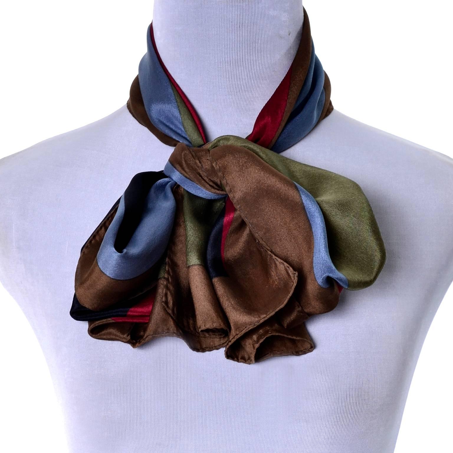 This vintage silk scarf from Kenzo has brown, green, sky blue, navy blue and red geometric shapes.  The scarf measures 58 by 10 inches and is in excellent condition! We love vintage Kenzo pieces and the color blocking triangles in this scarf make it