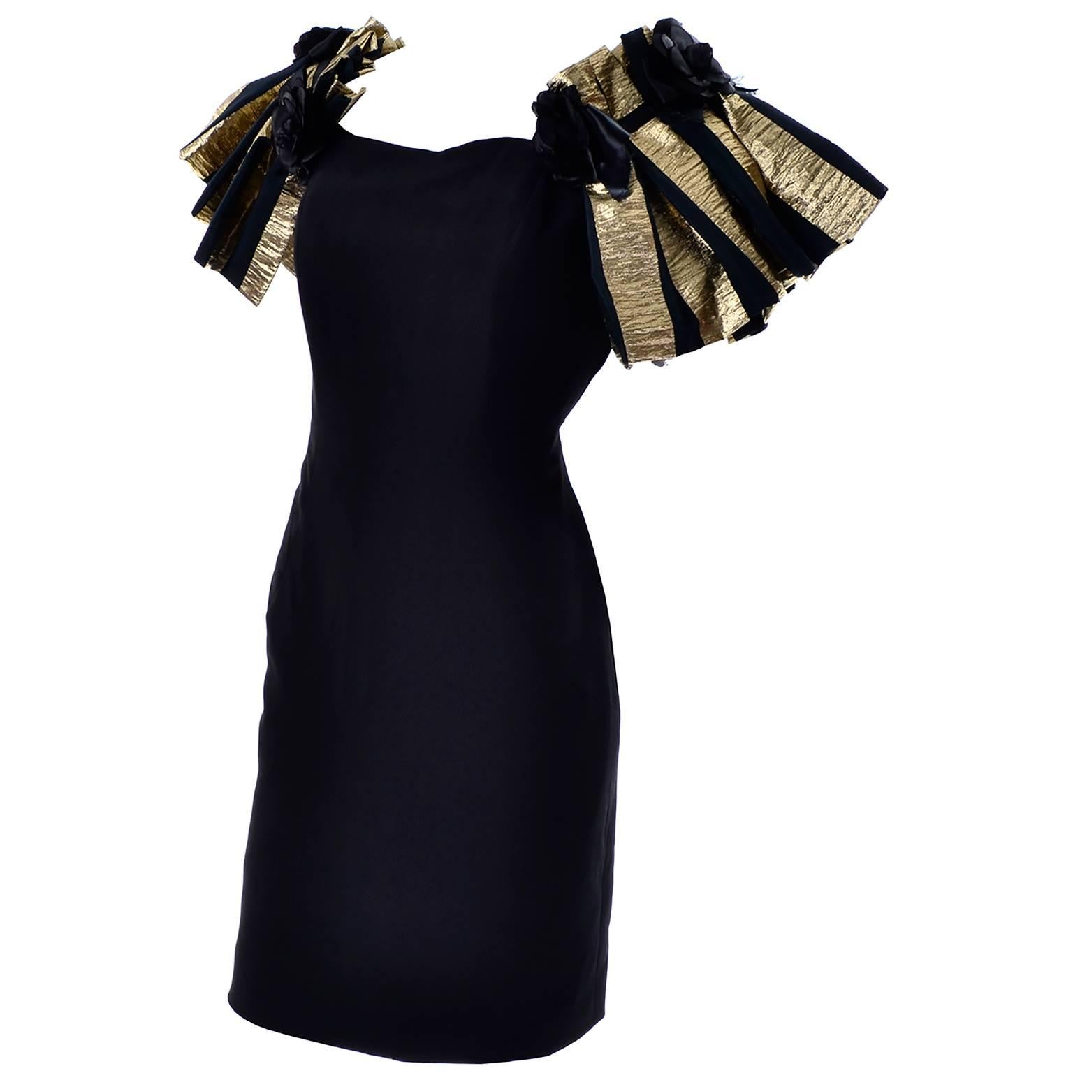 This is a stunning 1980's vintage little black dress by Victor Costa with incredible metallic gold striped sleeves. The straps are elastic underneath, with rose details in a band across the top. There is boning in the bodice, and the dress is fully