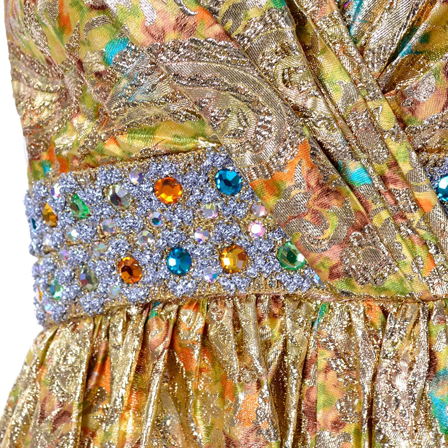 THE BEST JUMPSUIT EVER! A sensational 1960's goddess metallic jumpsuit in a yellow, green, blue and orange print with giant gold embroidered paisley design. There is a gelt of glittering rhinestones and gemstones in the same colors as the rest of