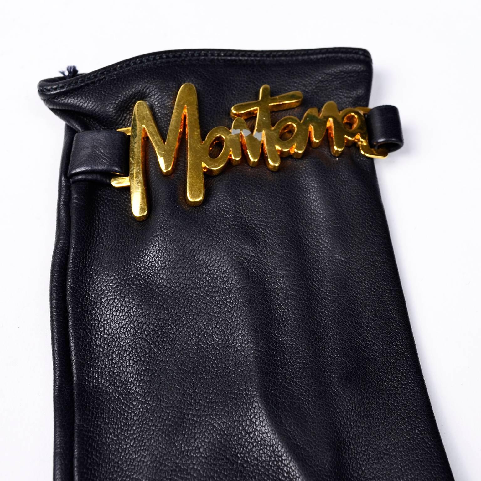 These are fabulous vintage Claude Montana black leather gloves with the word MONTANA across the wrists in gold tone metal.  These gloves have snaps in the back and measure 8 and 1/2 inches from the tip of the middle finger and 3