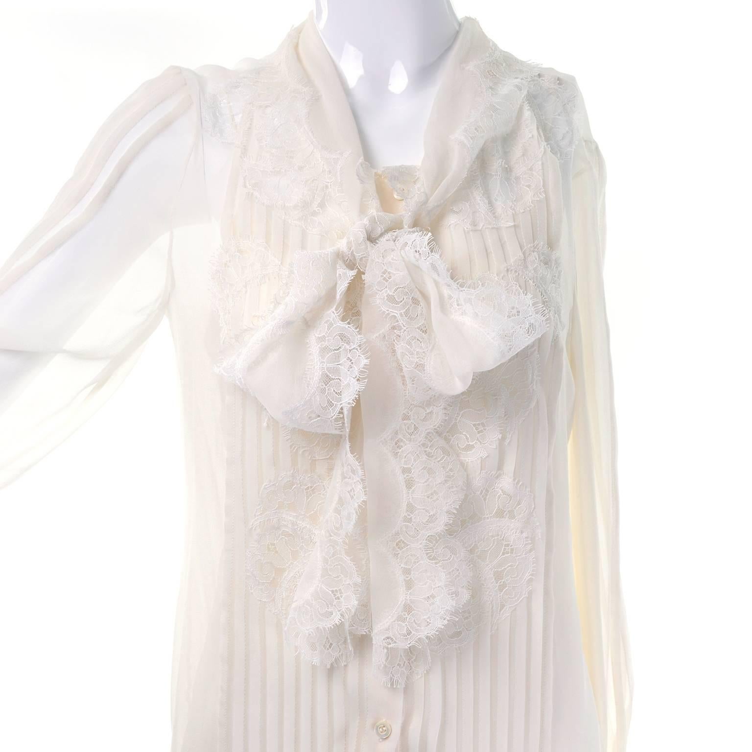 This is a gorgeous Oscar de la Renta sheer off white blouse with a lace pussy bow and matching camisole to wear underneath. This blouse has pleats along the front and down the sleeves. Marked as a size 8, and it is meant to be worn blousy.  This