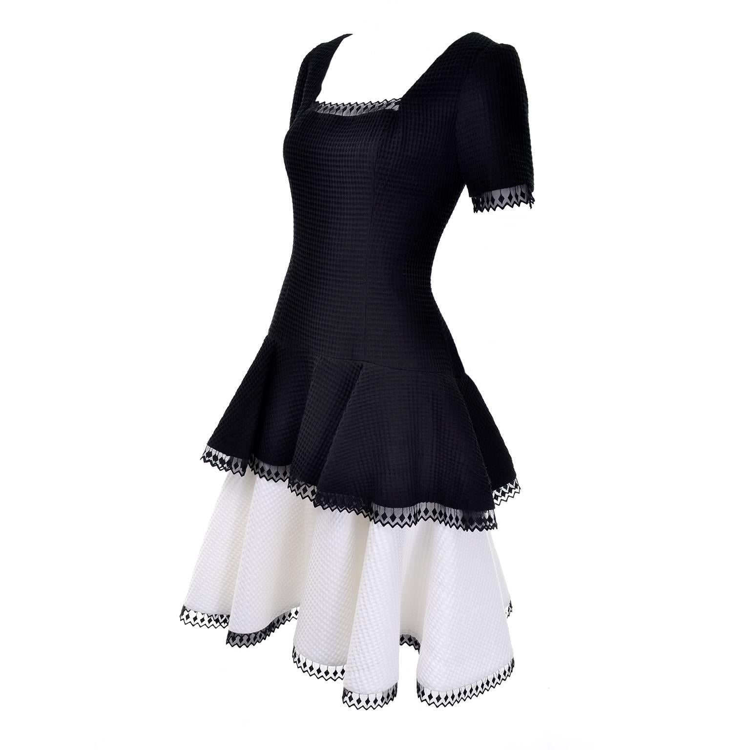 This vintage Victor Costa dress was purchased at the upscale boutique Lou Rose in the Montecito area of Santa Barbara in the 1980's. This black and white waffle weave dress is lined and has pretty lace trim and a layered skirt. There is a center