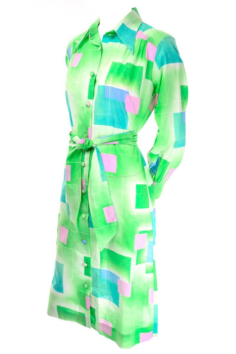 This vintage dress by Lanvin is from the 1970's and the fabric is covered in Green, pink and blue abstract squares.  The dress buttons up the front and has long sleeves with buttoned cuffs.  This dress comes with its original fabric belt and fits a