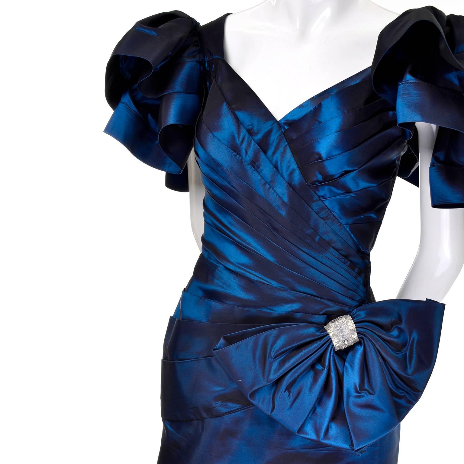 This is a beautiful vintage 1980's Tadashi iridescent blue dress with a side bow embellished with beading.  The dramatic statement sleeves are ruffled and the front is beautifully pleated and draped. The dress fits like a size 6 but please use the