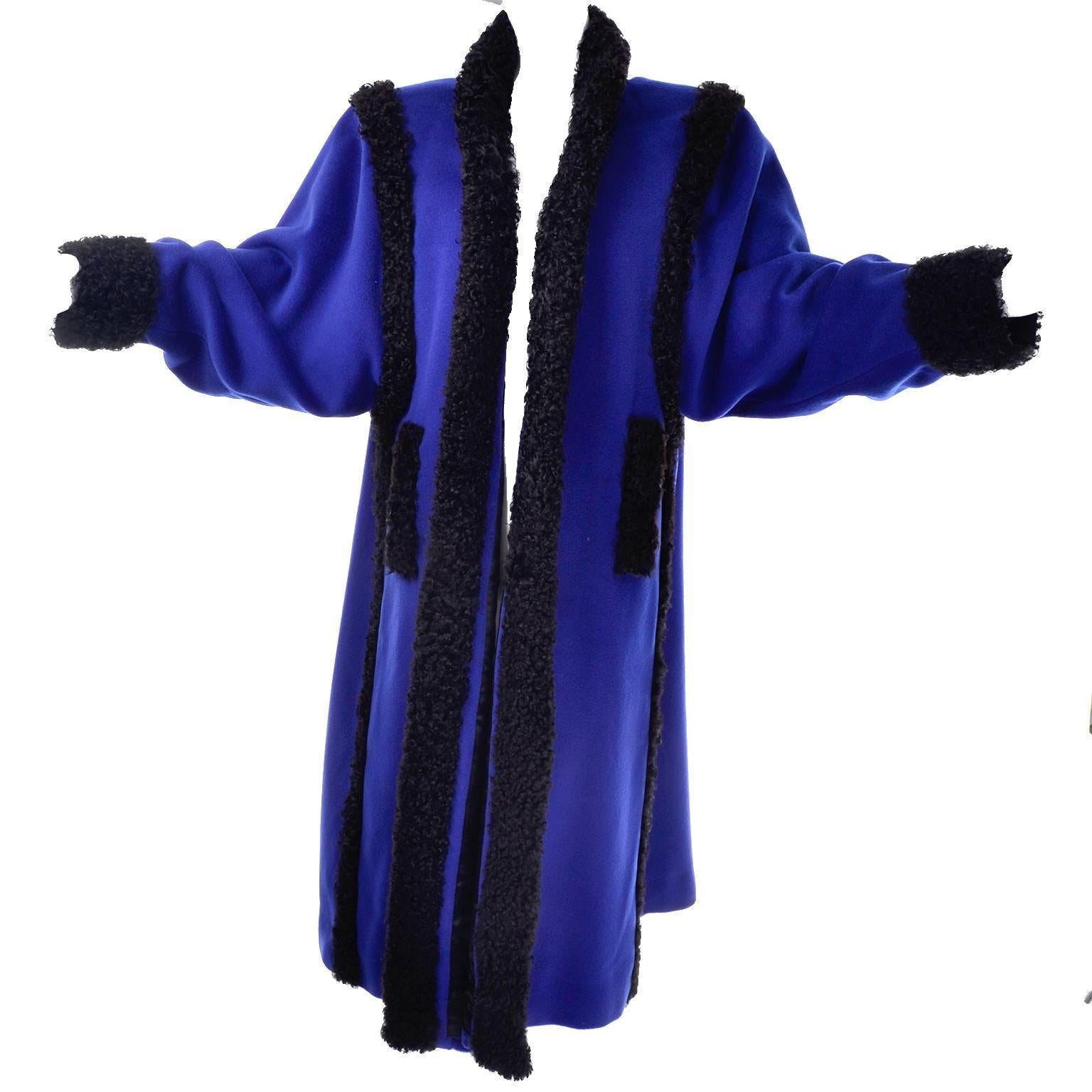 This is an outstanding vintage Yves Saint Laurent Rive Gauche long coat made of blue wool with curly black wool trim. This sensational, collectible coat is fully lined and has two pockets. Marked as size 38, and made in Paris, France, this coat has