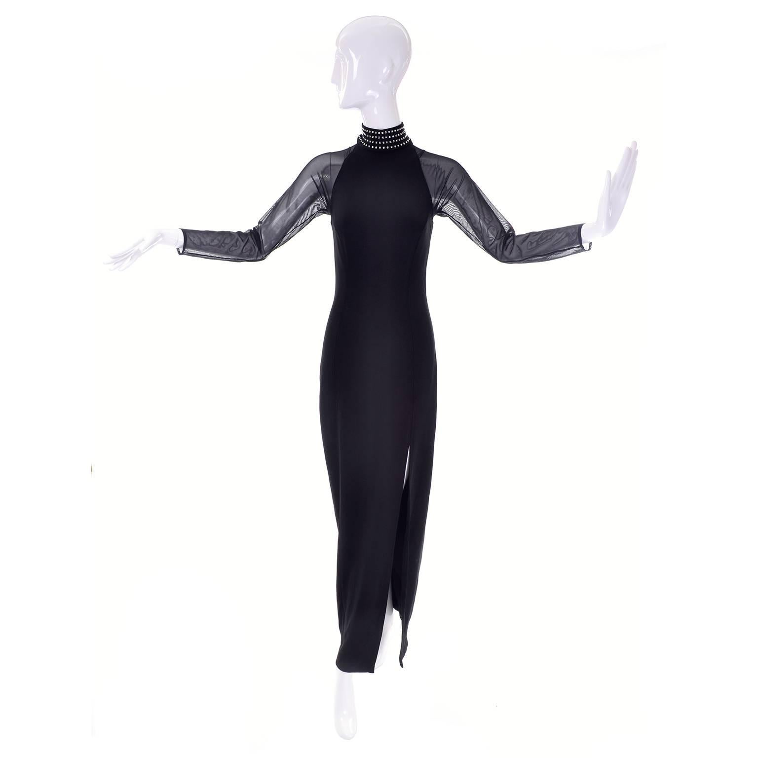 This black vintage Tadashi Lycra maxi dress has sheer long raglan sleeves and a dramatic studded high neck. The dress is from the late 1980's or early 1990's. There are square rhinestones that run around the mock turtleneck. This dress was made with