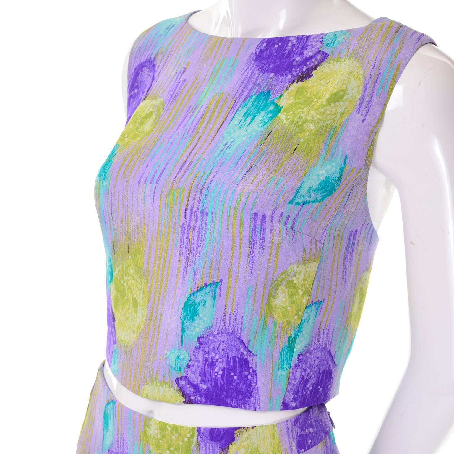 This is an outstanding 1999 deadstock Gianni Versace Couture 2 piece dress with a silk crop top and skirt in an abstract floral design. This gorgeous ensemble has its original tags and was never worn. The fabric is a pale purple base silk with