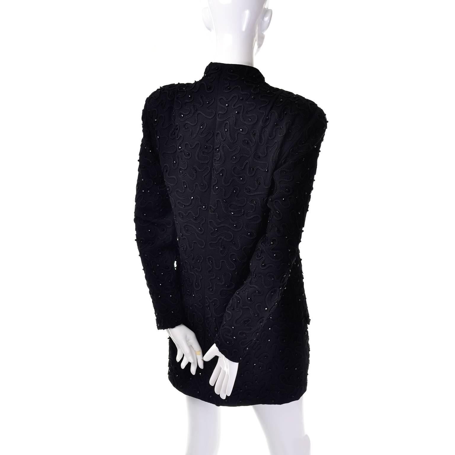 This is a gorgeous 1980's black Donna Karan New York Wool Blazer Jacket with beading and swirl raised embroidered design. Decorative buttons run down the front of this jacket, with hidden snap closures underneath. There are shoulder pads and long