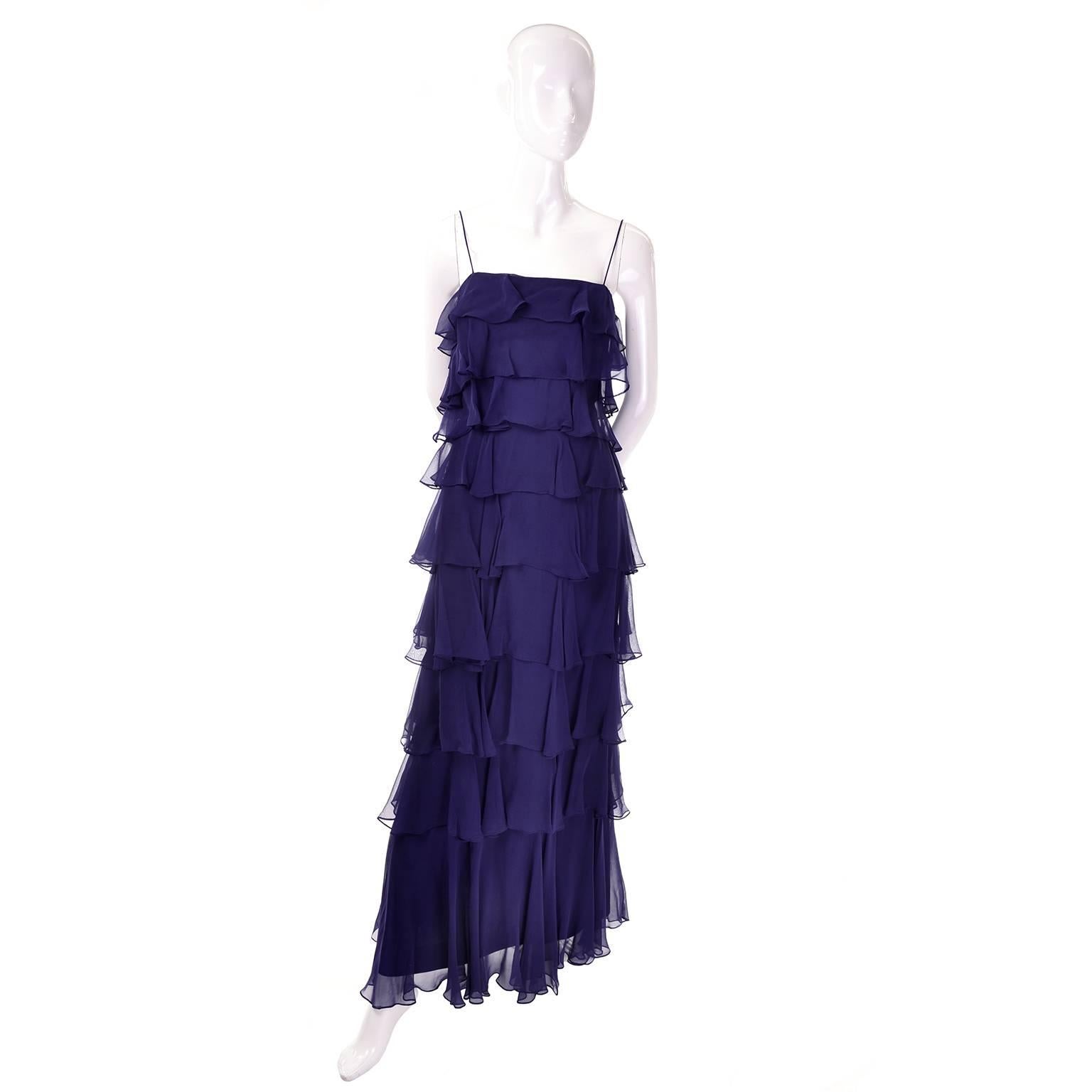 This is a great vintage Fred Perlberg navy blue silk chiffon ruffled vintage dress with a matching shawl. This dramatic long navy maxi dress has a sheer chiffon tiered ruffle overlay and spaghetti straps. Zips up the back and comes with a sheer
