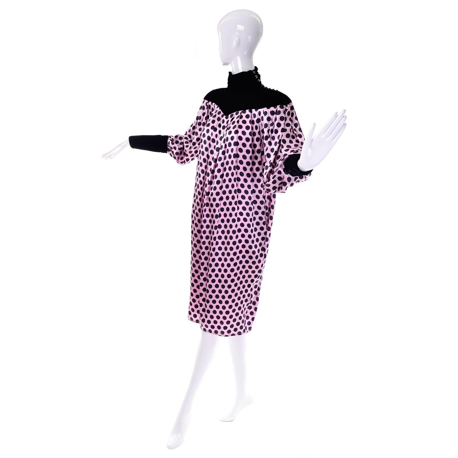 This is a stunning Ungaro vintage 1980's pink silk dress with black polka dots, black velvet turtleneck and mutton sleeves. The dress is so easy to wear and nicely pleated down the entire center front and back. It has a gathered black velvet