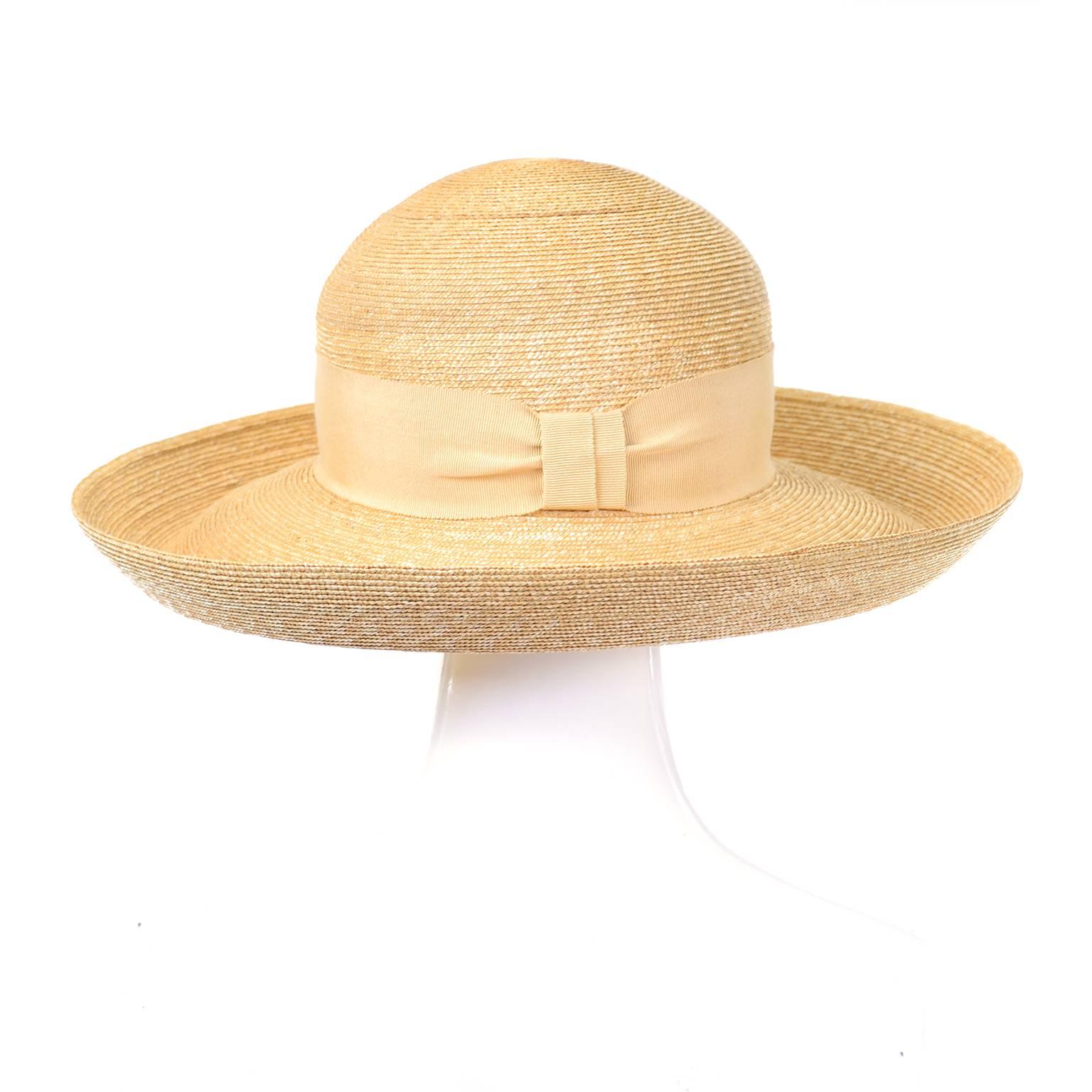 This pretty vintage straw hat is from the fabulous Milliner Patricia Underwood. The hat has a thick cream ribbon around the head and a bow in the back. The brim turns up at the ends and measures 4.5