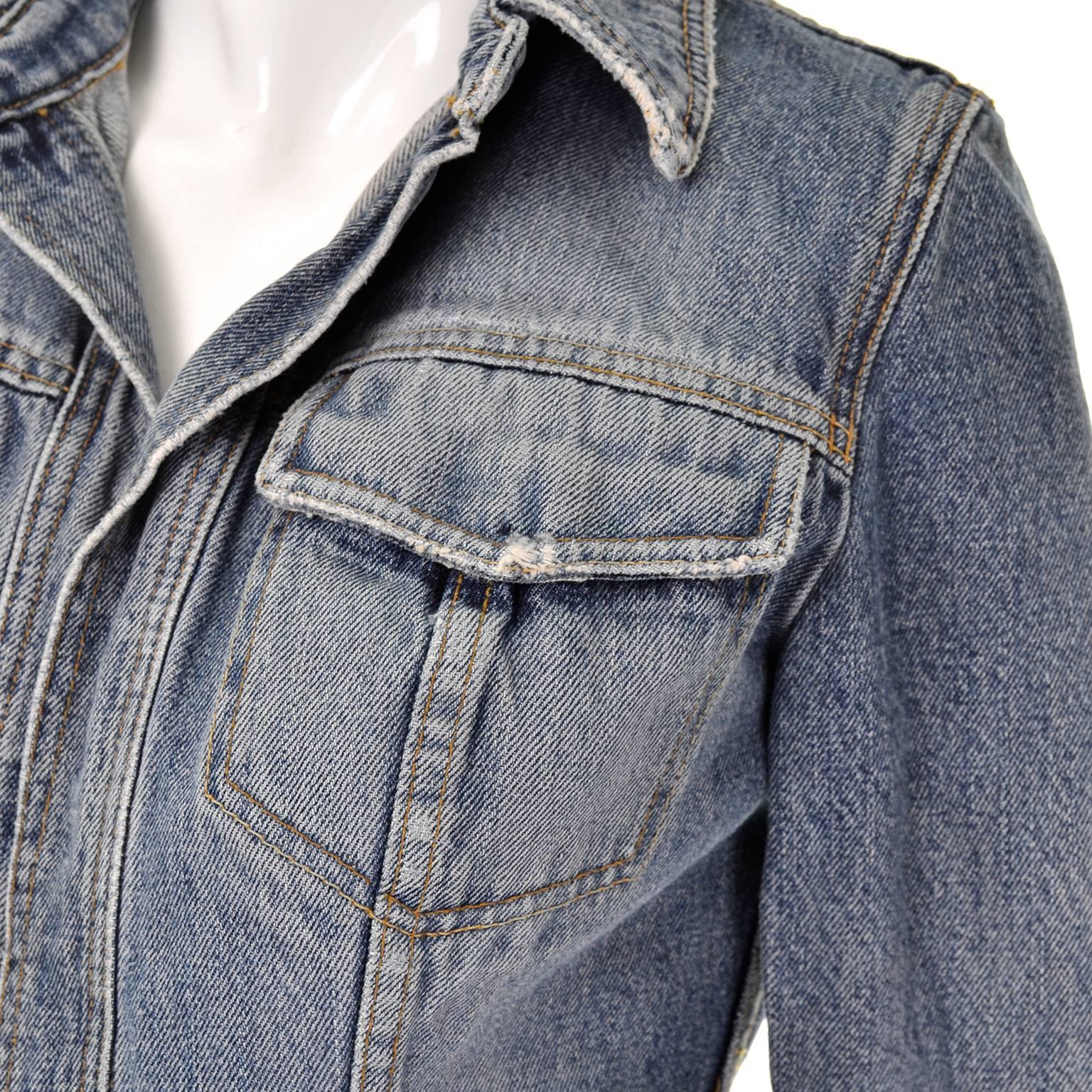 This is a great Dolce & Gabbana denim  jacket with distressing along the collar, pockets and hem. We love this jean jacket and it the way it opens in the front with no buttons or hardware. This piece is 100% cotton and was made in Italy. The jacket