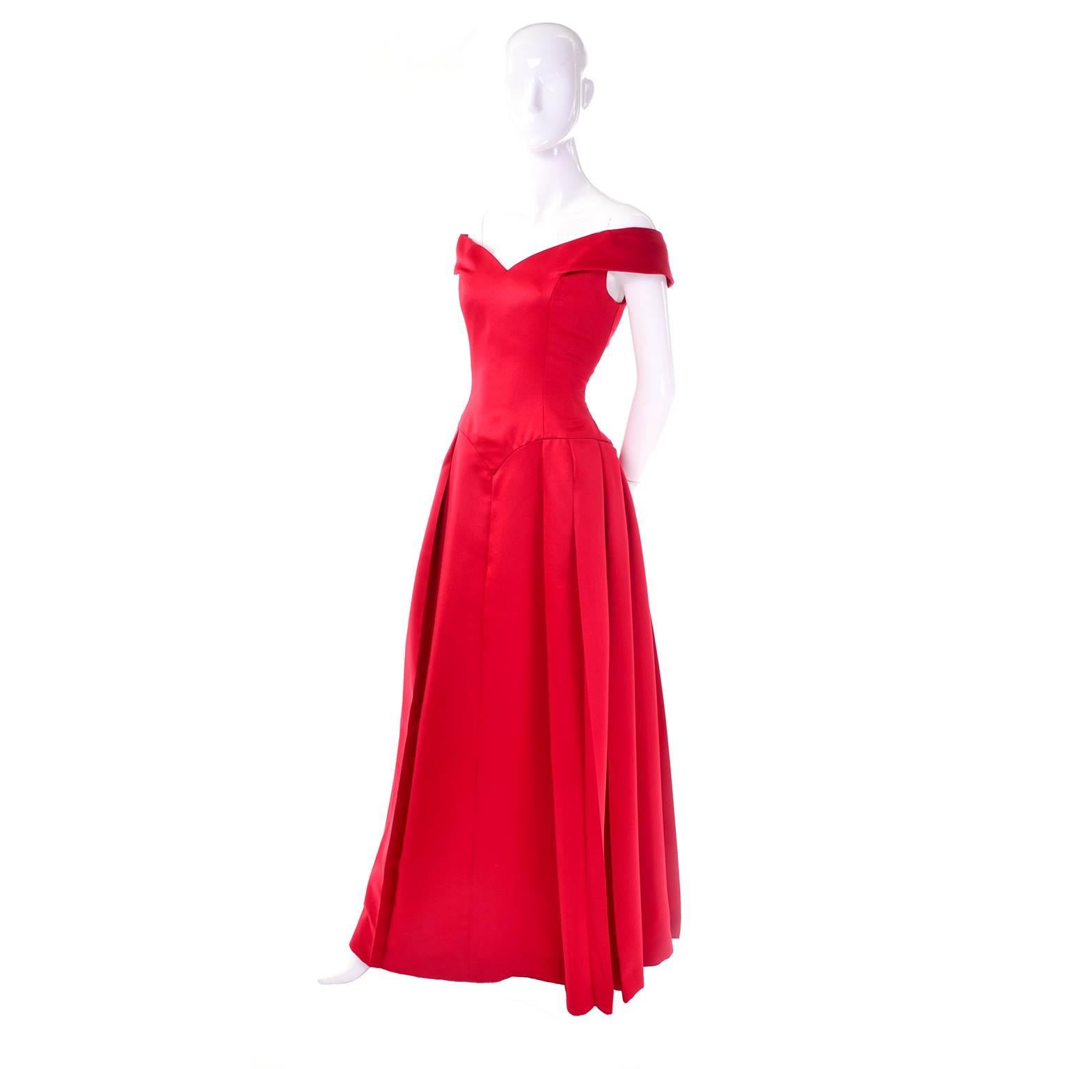 This is a beautiful Victor Costa Boutique red evening gown from I. Magnin in excellent condition. The full skirt of this beautiful ballgown is lined with a red netting, and the shoulders have an attached covered elastic inside to help them sit