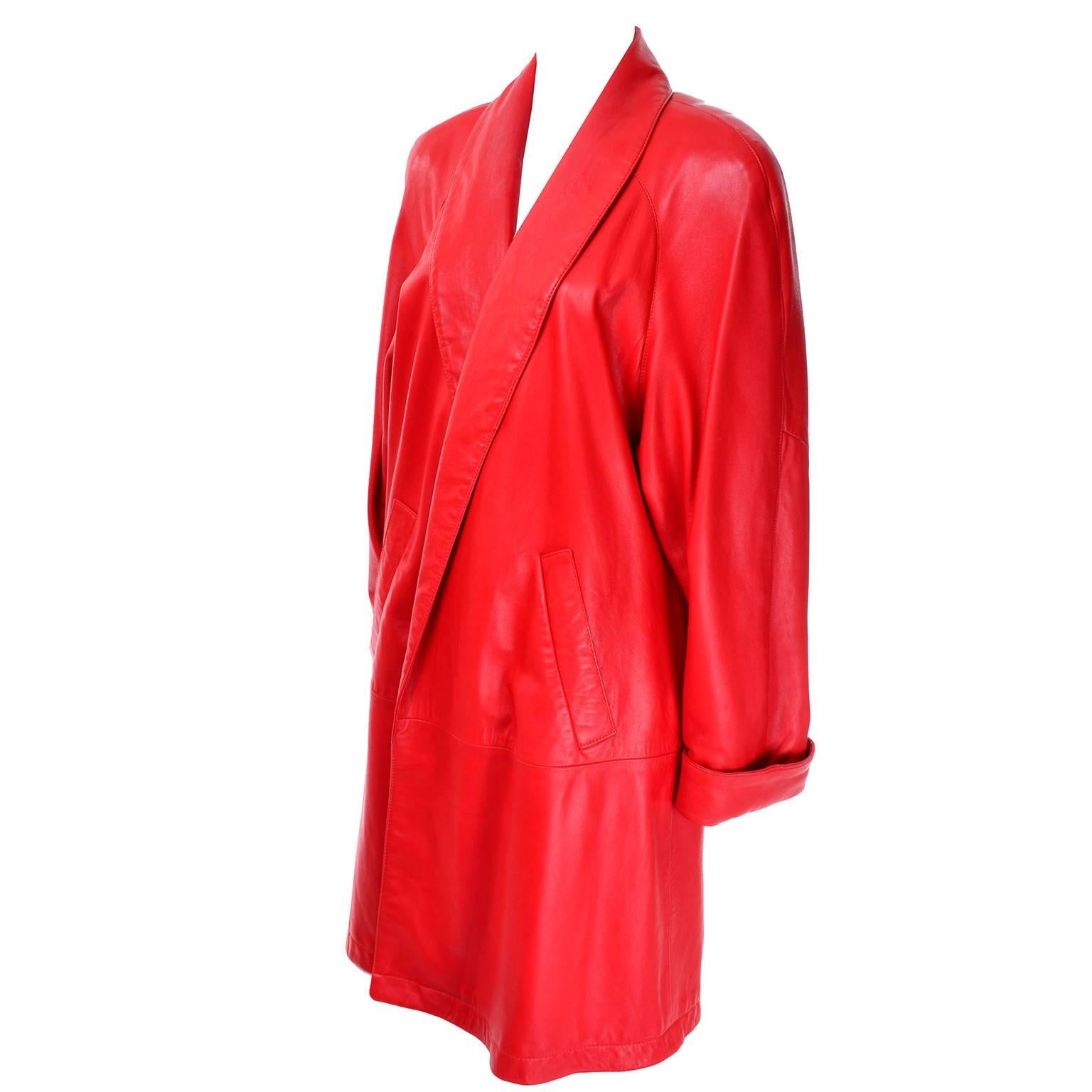 This is a 1980's Vakko long leather coat in a fiery red-orange! This extremely soft leather jacket is open in the front, with dramatic shoulder pads and hip pockets. The sleeves can be worn long or cuffed, and the jacket is fully lined. Excellent