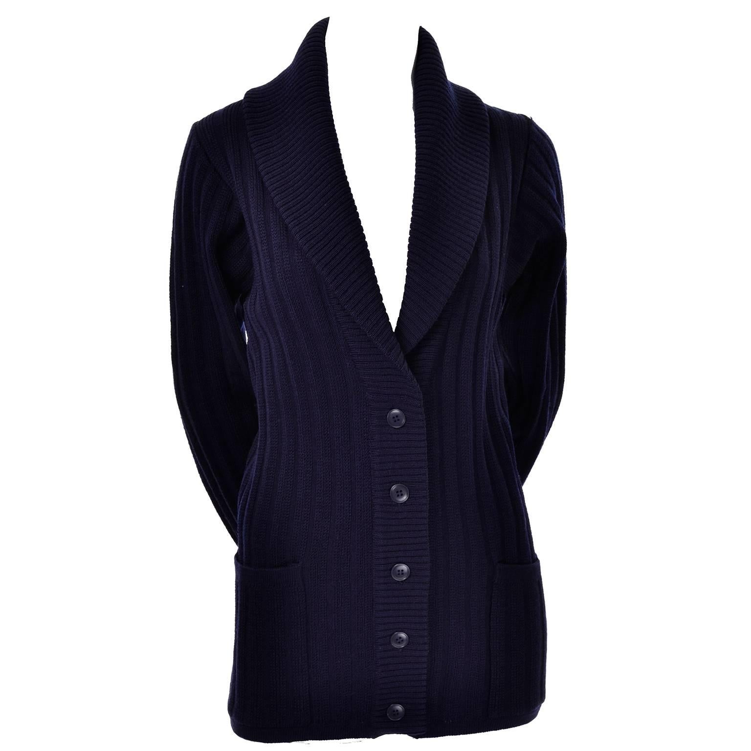 This navy blue wool ribbed knit vintage cardigan was designed by Yves Saint Laurent in the late 1970's.  This is a beautiful cardigan with a large shawl collar and rolled cuff sleeves. This sweater buttons up the front, and has two front pockets.