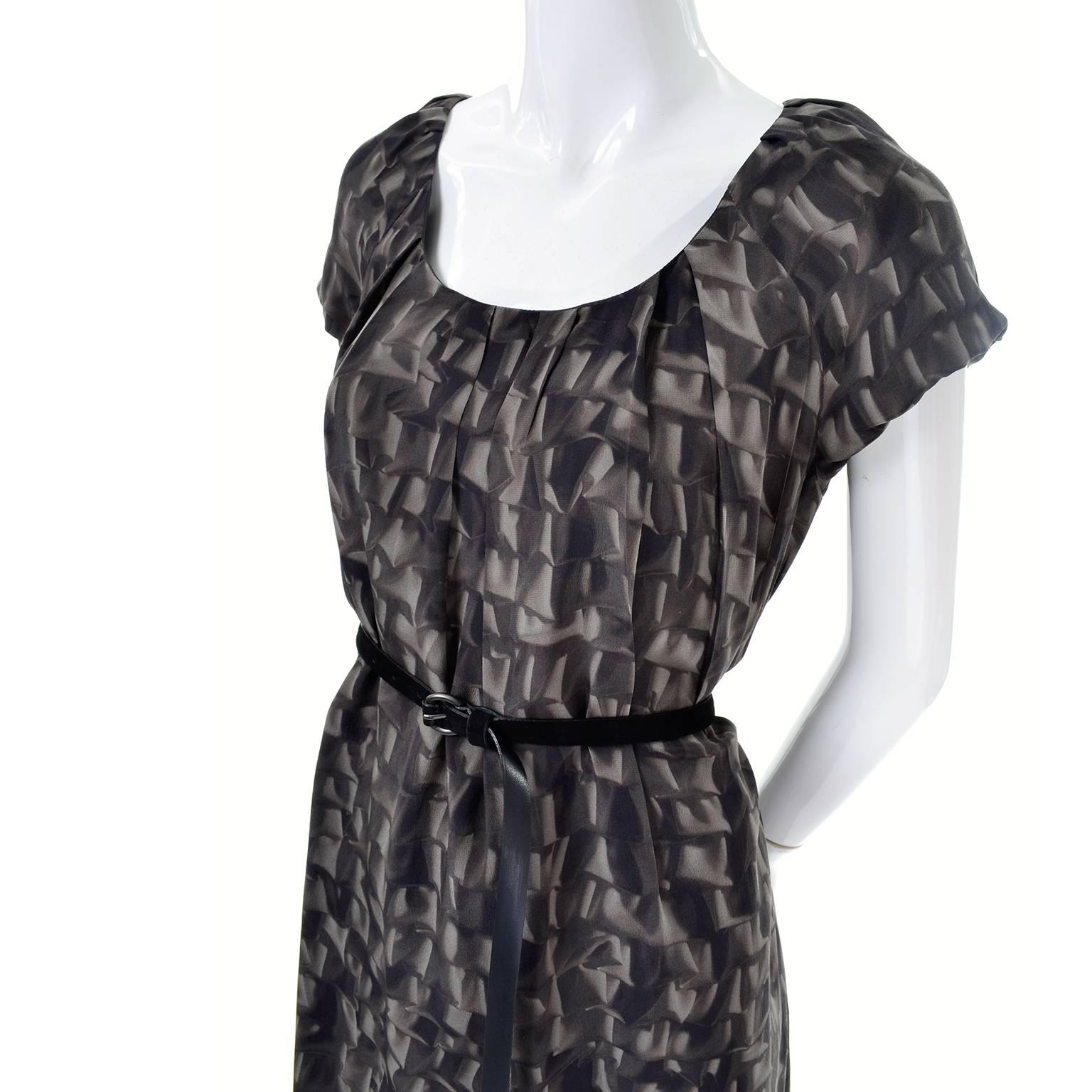 This is a great Moschino Cheap and Chic silk dress with a unique abstract ruffle print. At first glance, you might not notice the pattern, but once worn, you can see the abstract pattern of the fabric!  This dress has a black suede belt that fits