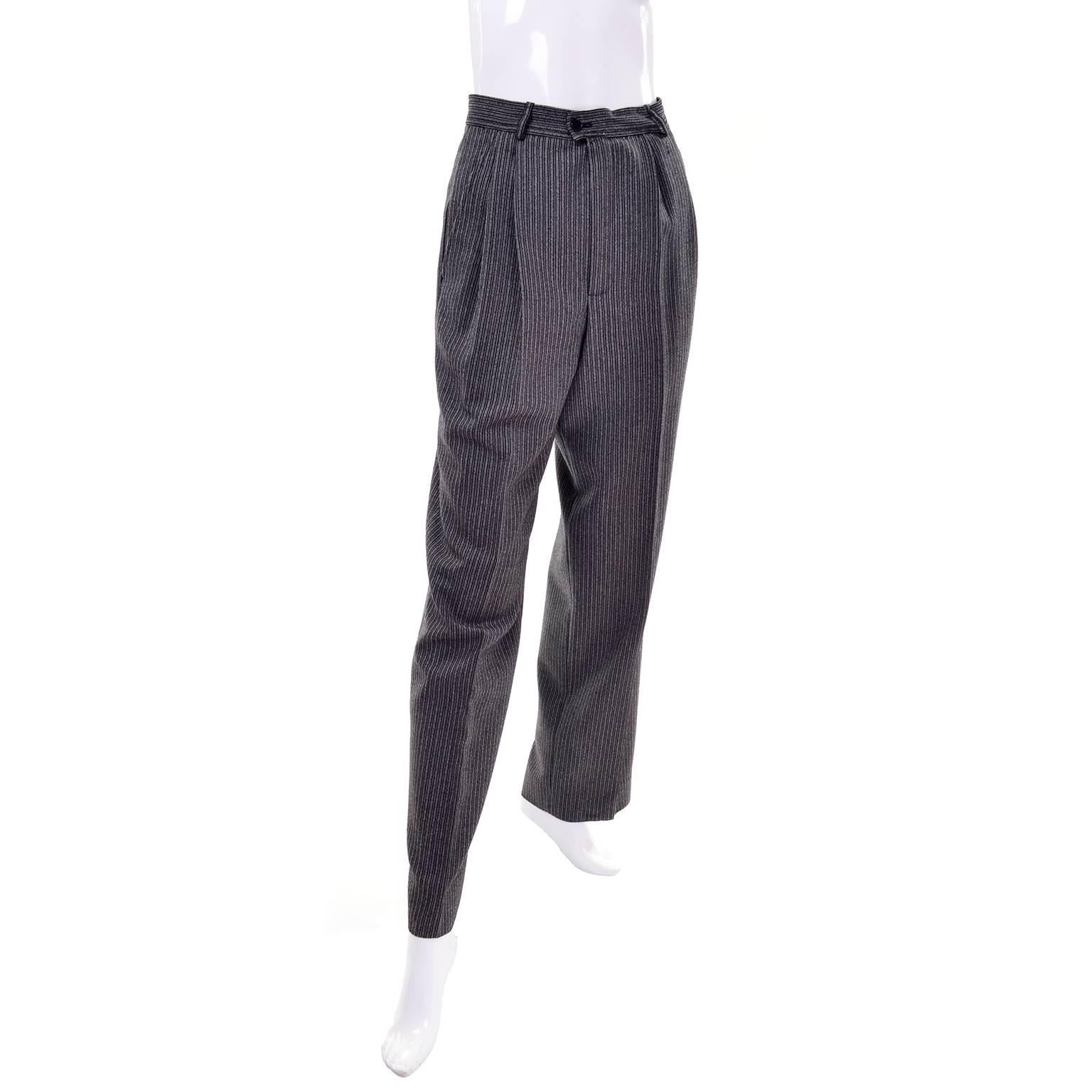 These vintage YSL Rive Gauche gray and black pinstripe wool pants are high waisted and have side slit pockets. The pants are in excellent condition and have slight pleats. These pants fit our mannequin to a T so we estimate them to be a modern day