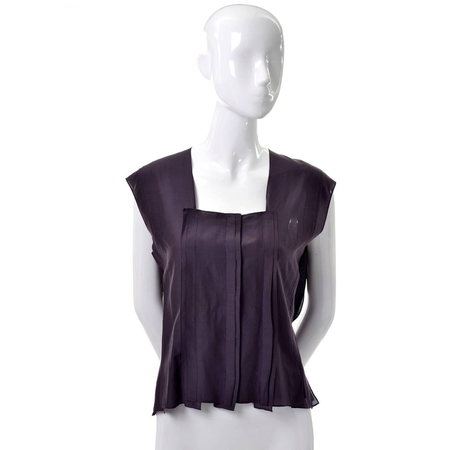 This is such a beautifully made Tom Ford for Yves Saint Laurent top with pretty top stitched pleating and hidden buttons up the front. There are unique panels that are semi open in the back that are hard to describe but remind of us contemporary