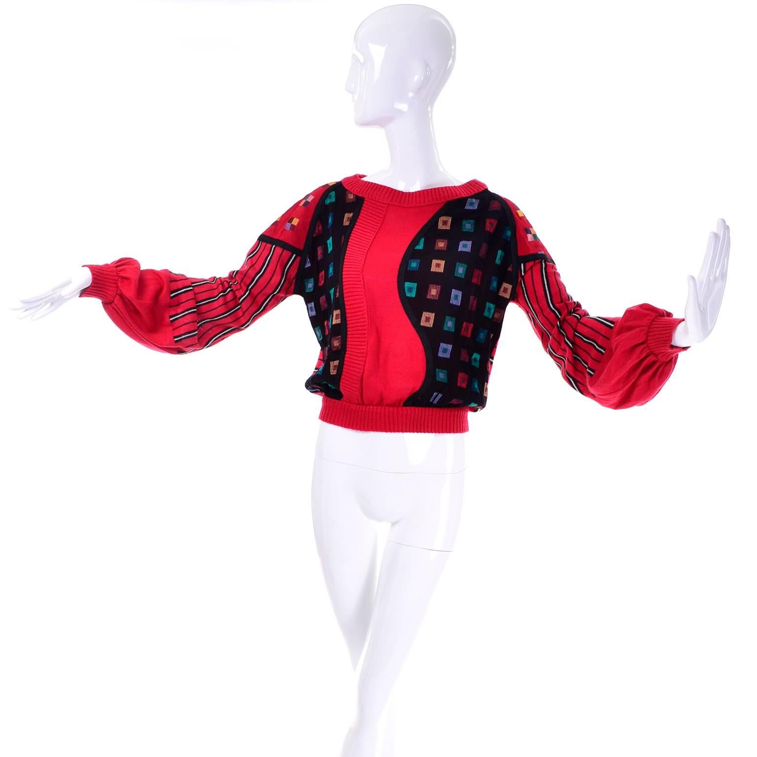 This very unique multi fabric and mixed pattern vintage sweater was designed by Koos Van Den Akker in the 1980's.  This fabulous sweater has red silk or possibly silk/wool blend knit fabric, as well as silk patterned fabric in red and black.  The