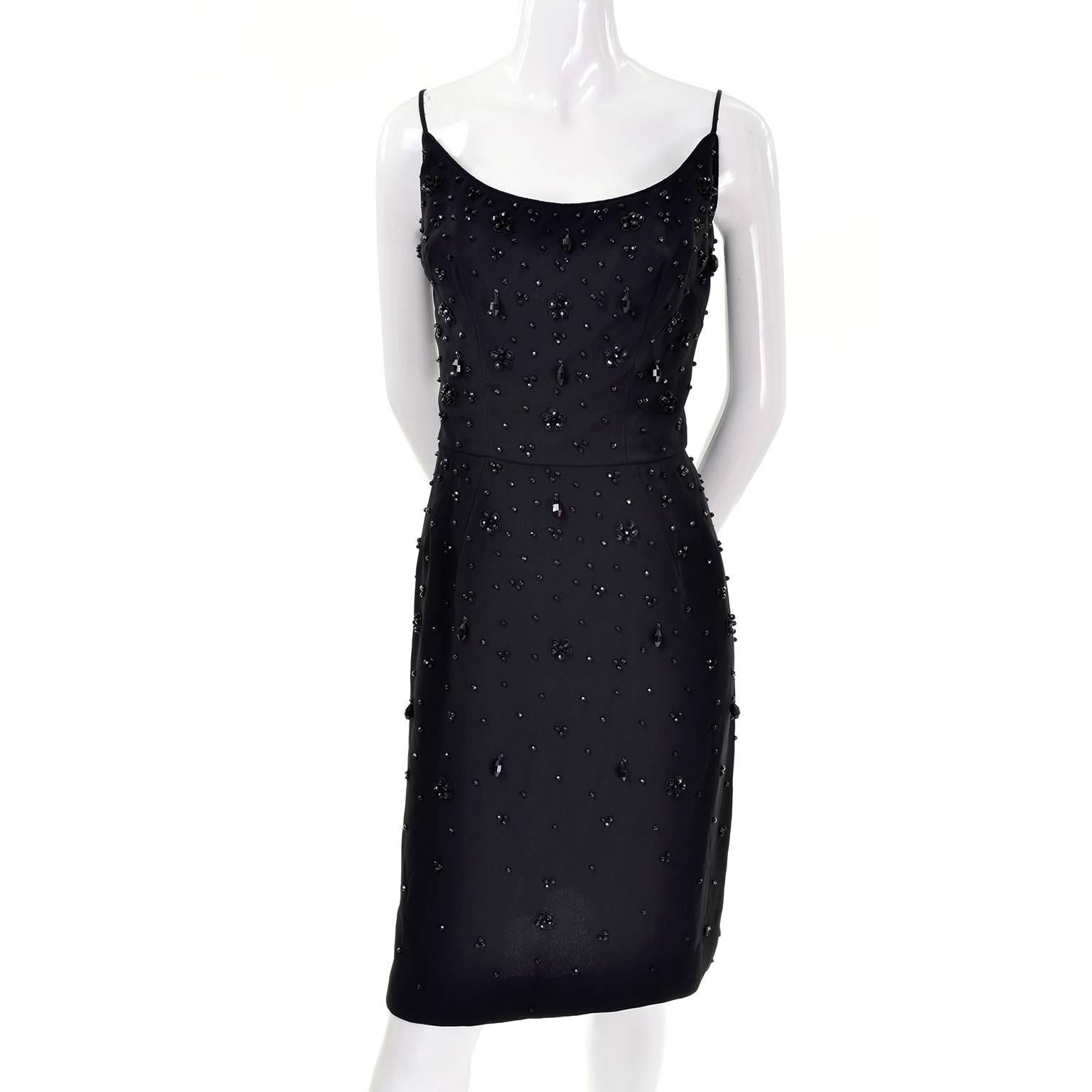 This is a sexy 1960's sleeveless black crepe cocktail dress that is dripping with faceted black beads in a variety of sizes. This great little black dress has spaghetti straps, a fitted waist and a back zipper.  We estimate this dress to fit a