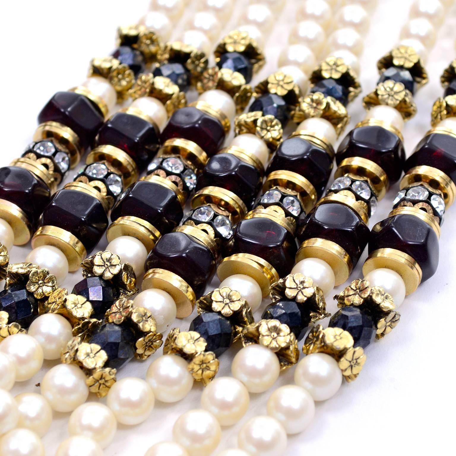 This is a fabulous vintage 1960's 7 strand necklace with faux pearls, black faceted beads, gold spacers and rhinestones.  The necklace is 20