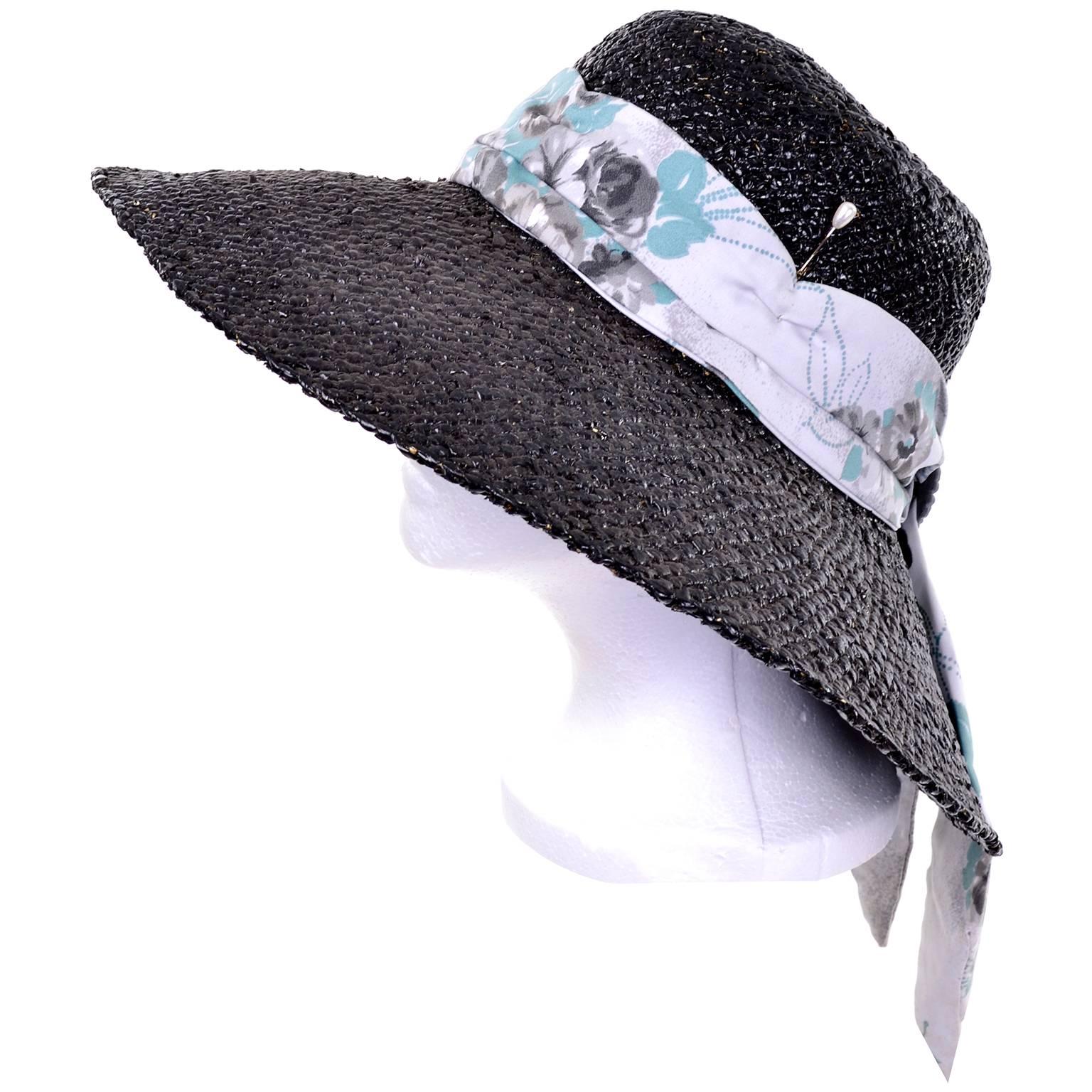 This mid century vintage black painted straw hat was designed by Mr. Blackwell. Mr. Blackwell made hats for his socialite female friends and celebrities and this is the only hat designed by him that I've ever seen. The hat has a scarf and buckle and