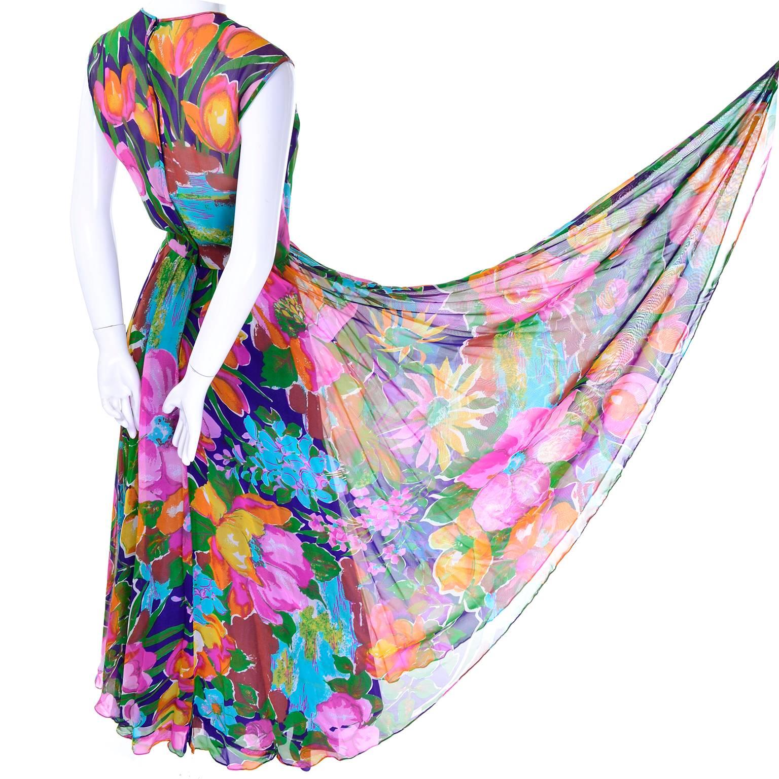 This is a great vintage chiffon dress in a bold chiffon floral print from the 1970's. The upper part of the bodice is semi sheer and the rest of the dress is lined in green satin.  the dress has a fitted waist and full skirt and closes with a back