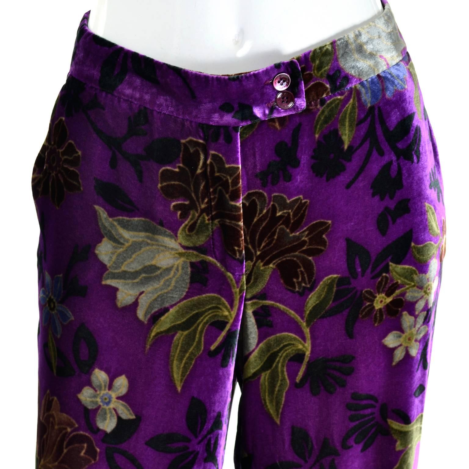 These luxuriously soft purple floral velvet pants from Etro are made of a silk and rayon blend fabric in shades of purple, green and brown.  Perfect for Fall and winter, these wide legged pants have side slit pockets and they close with a front