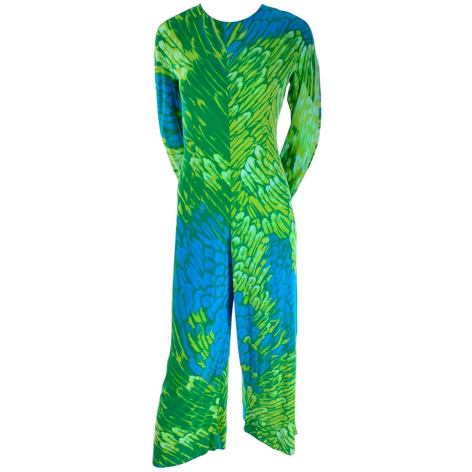 This vintage silk jersey jumpsuit is from the late 1960's or early 1970's and it comes with a matching sheer silk chiffon one shoulder sarong that slips over your head. The jumpsuit has a great abstract blue and green print, it zips up the back and