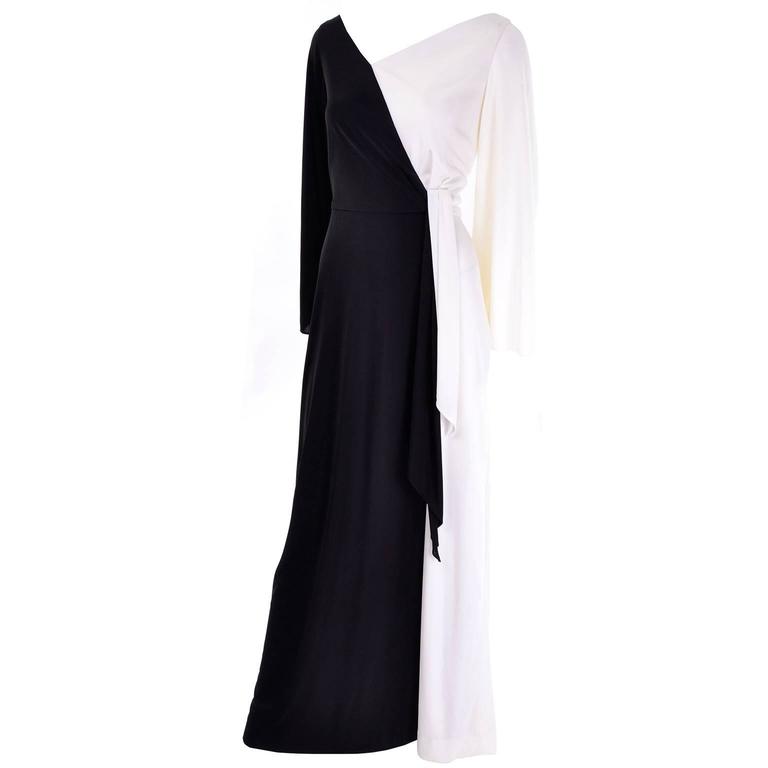 This 1970's vintage dress was from the Eva Gabor collection by Estevez. This vintage jersey maxi dress is black and white with a back zipper and long sleeves. The back has an asymmetrical V and there is a front side swag. We estimate this dress to