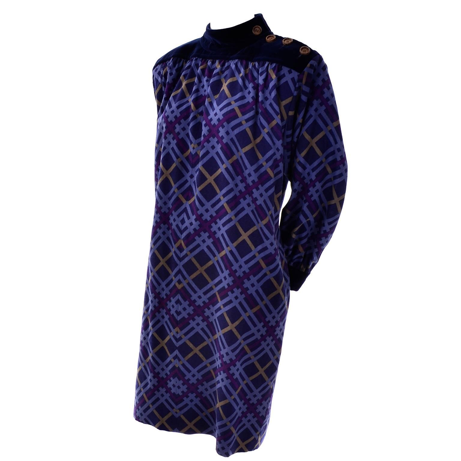 This vintage YSL dress was designed by Yves Saint Laurent in the late 1970's. The dress is wool with a purple, blue and mustard plaid on a dark blue background. The mock turtleneck and shoulders are blue velvet and there are 4 wood buttons on the