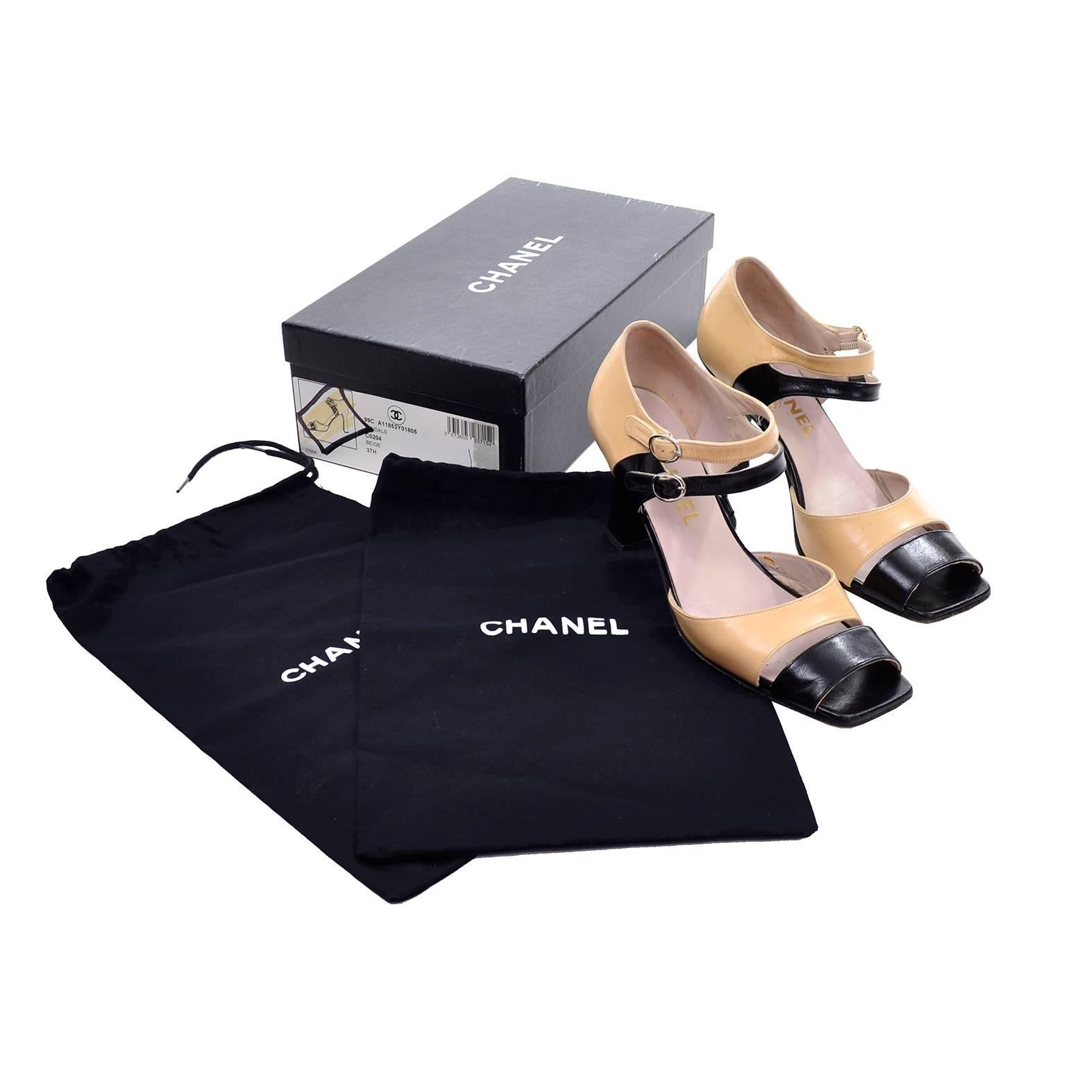 These late 1980's classic two tone beige and black Chanel shoes come with their original box and shoe bags! These shoes are from an incredible estate of beautiful designer vintage shoes and clothing.  The shoes are labeled a size 37.5 and the