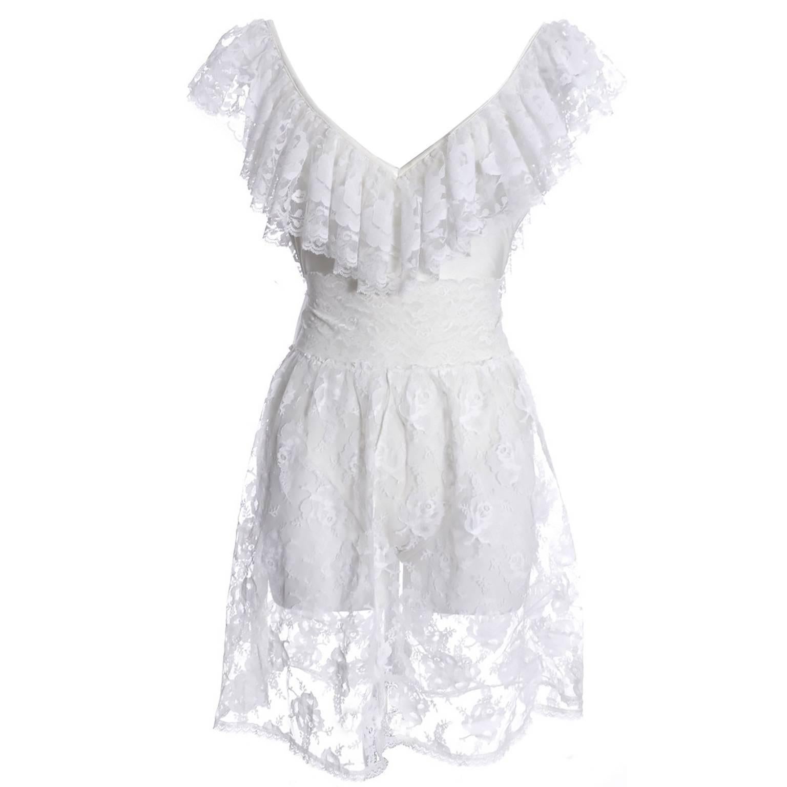 You will feel so glamorous in this fabulous one piece vintage Bill Blass swimsuit with its matching lace skirt! The swimsuit itself has beautiful white lace trim and the white lace over skirt is 21 inches long with a 26