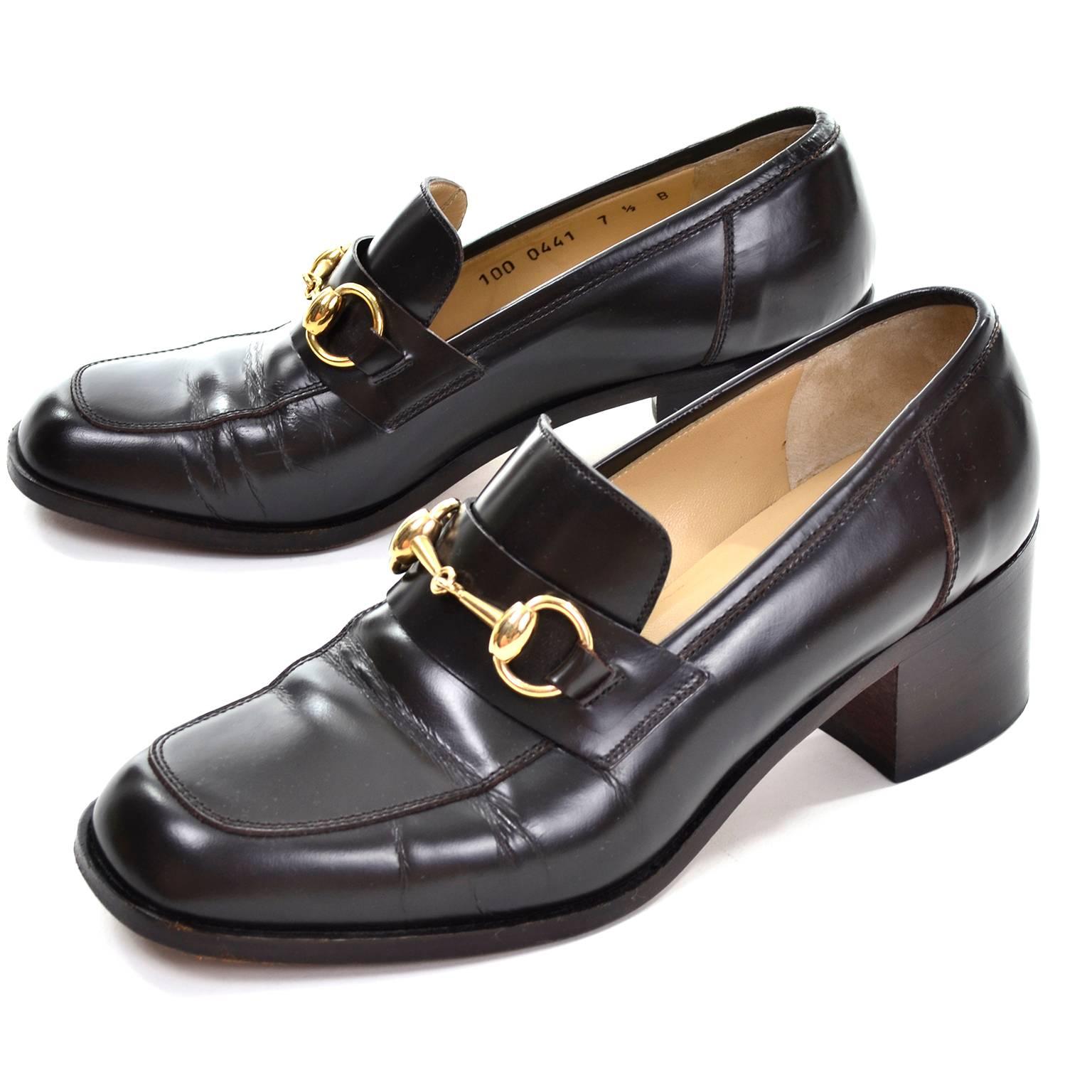 These classic brown leather vintage Gucci loafers have beautiful horsebit brass buckles and 2 inch chunky heels. These timeless shoes were made in Italy and are marked a size 7 and 1/2 and are 3 and 1/4