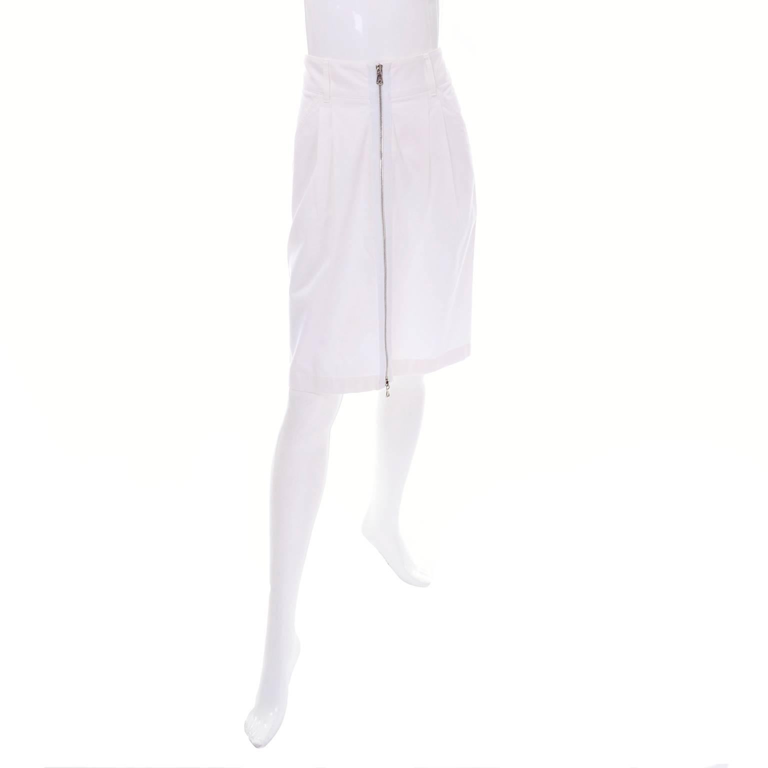 White pencil skirt by Dolce & Gabbana from the 1990's with a zipper down the front of the skirt. There are two zipper pulls, allowing you to wear it as a pencil skirt, or create a slit in the front. This skirt is worn at the waist, with large belt