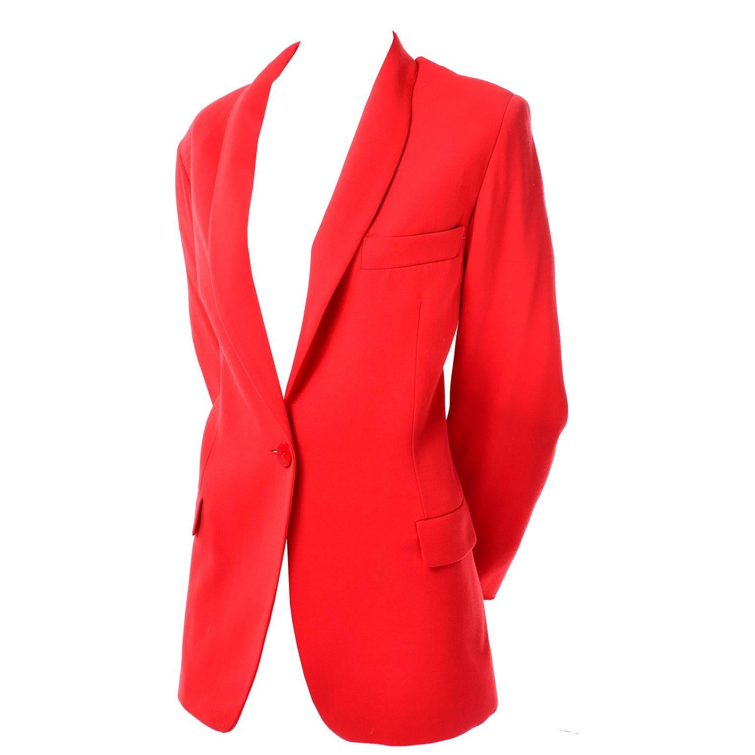 This gorgeous red-orange Giorgio Armani vintage wool blazer was made in Italy in the 1990's.  The jacket closes with a single button and has the traditional 3 front pockets. The fabric content indicates that it is 100% Wool with an acetate/rayon