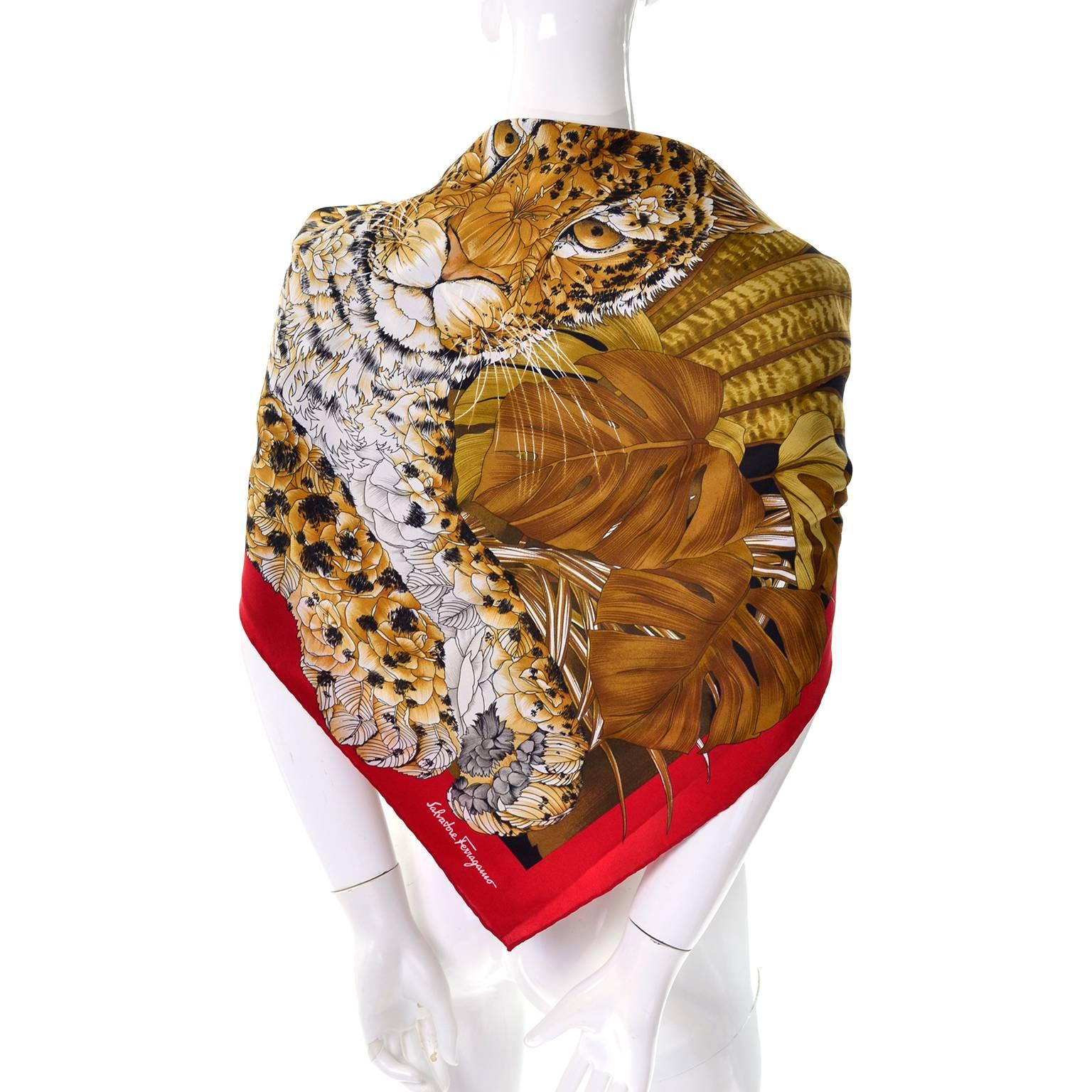 This is a sensational 34" vintage silk scarf from Salvatore Ferragamo. The scarf has a leopard in the jungle print in red, gold and brown and hand rolled edges.  This beautiful vintage scarf was made in Italy and is in excellent condition.