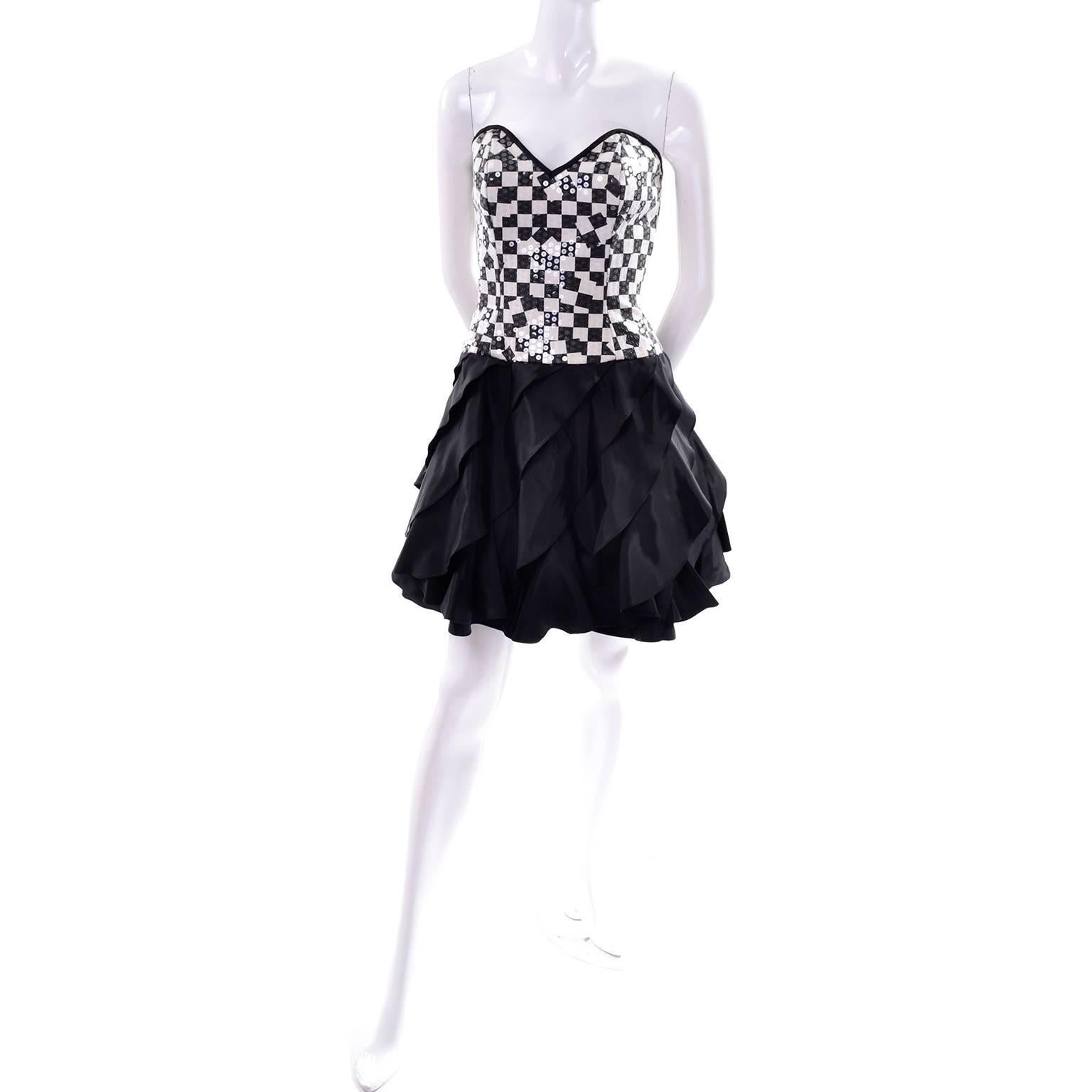 This amazing vintage Lillie Rubin party dress is from the 1980's and has a cotton black and ivory checked bodice that is covered with clear and pale ivory sequins.  The dress has stays in the bodice, a tiered ruffled taffeta skirt and a zipper up