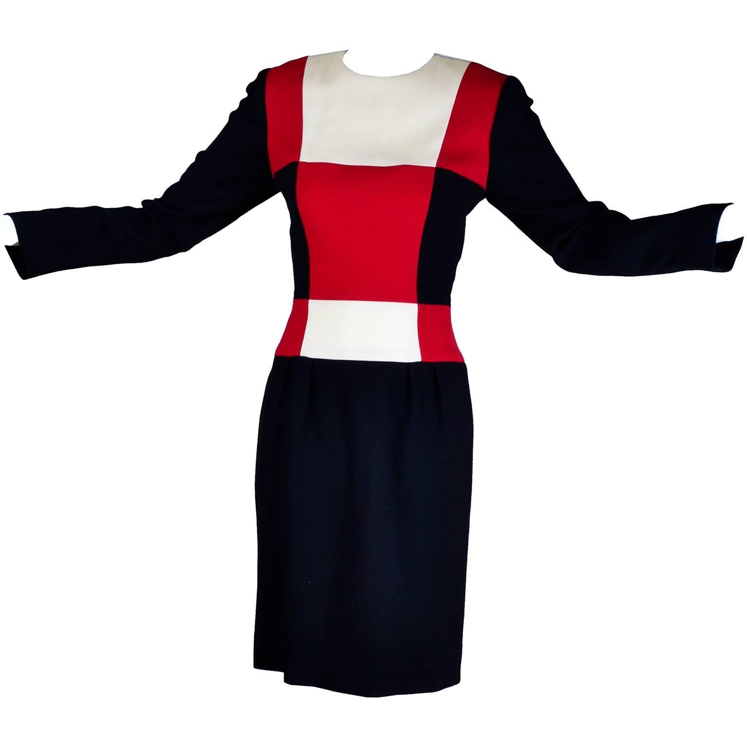 This vintage Scaasi dress is from the 1980's and has a hidden back zipper and great color block design. The fabric is a black wool crepe or wool blend with red, black and cream squares that go from the shoulders to the beginning of the hips.  The