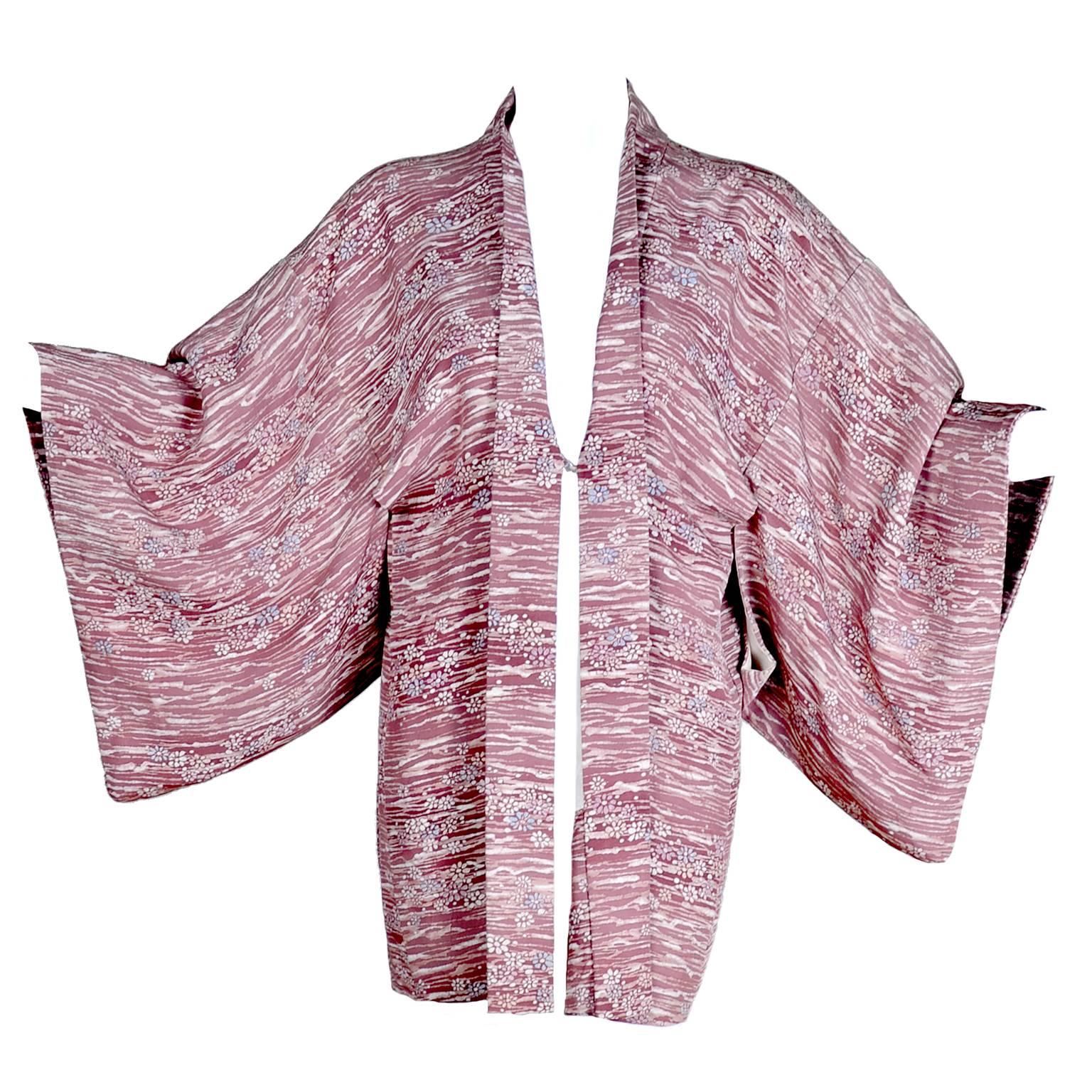 This is a lovely silk kimono in a hand dyed cherry blossom print in shades of burgundy and a hint of blue.  This beautiful vintage kimono can be worn as a jacket over a dress or a pair of pants.  The kimono is from an estate of collectible textiles