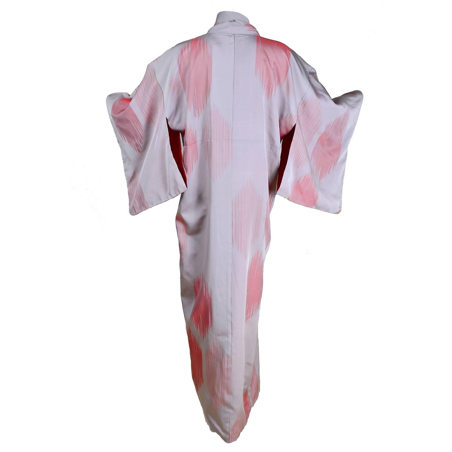 This beautiful vintage Kimono is a pale grayish purple, almost taupe, silk or rayon with salmon abstract designs and is lined in purple silk.  We love kimonos and acquired this from an estate we purchased that had an extensive collection of Japanese