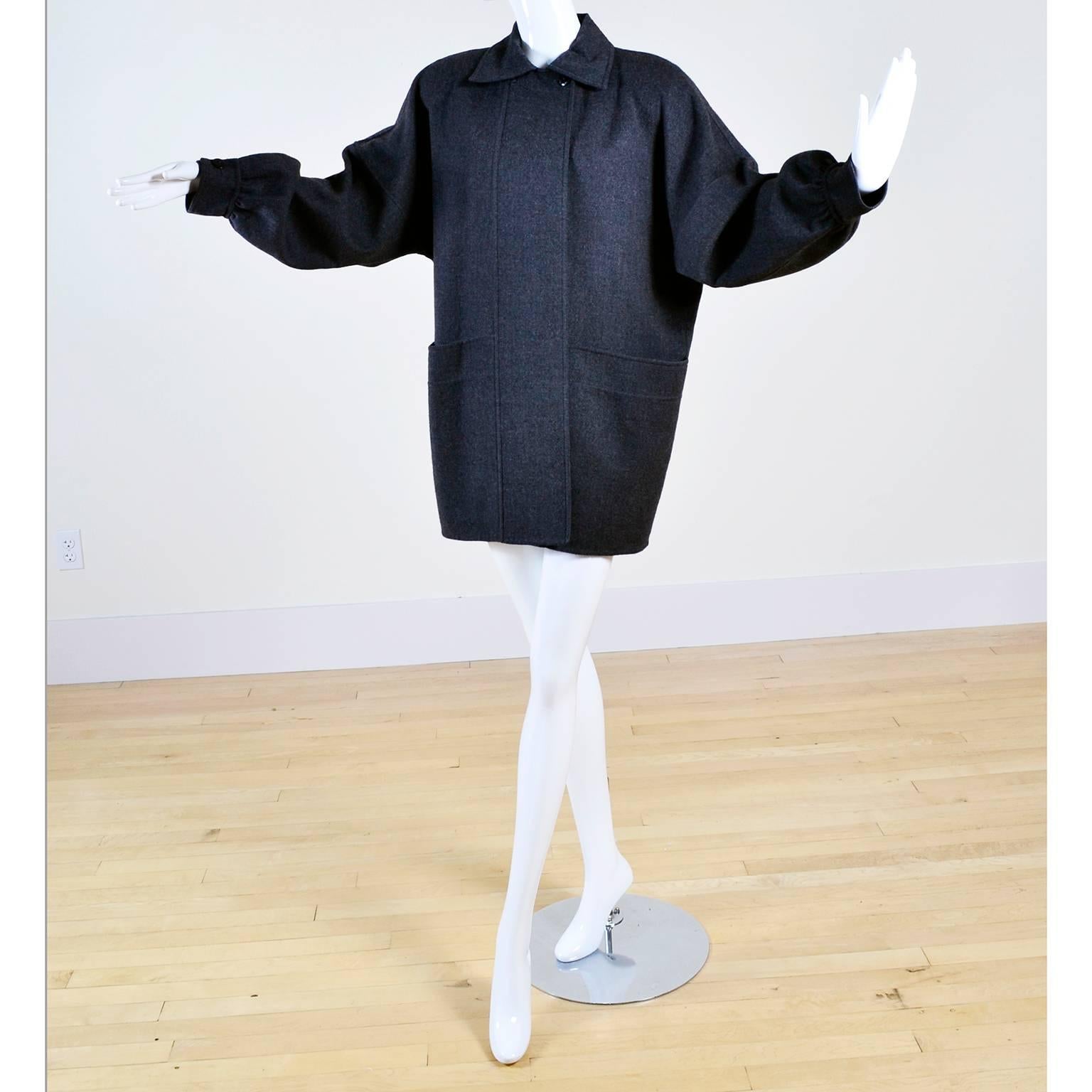 This is a fabulous 1980's Salvatore Ferragamo vintage gray wool jacket with front pockets. This would make a great addition to any Fall and Winter wardrobe!  This versatile coat is from the has that classic 80's oversized fit and puff sleeves.  This