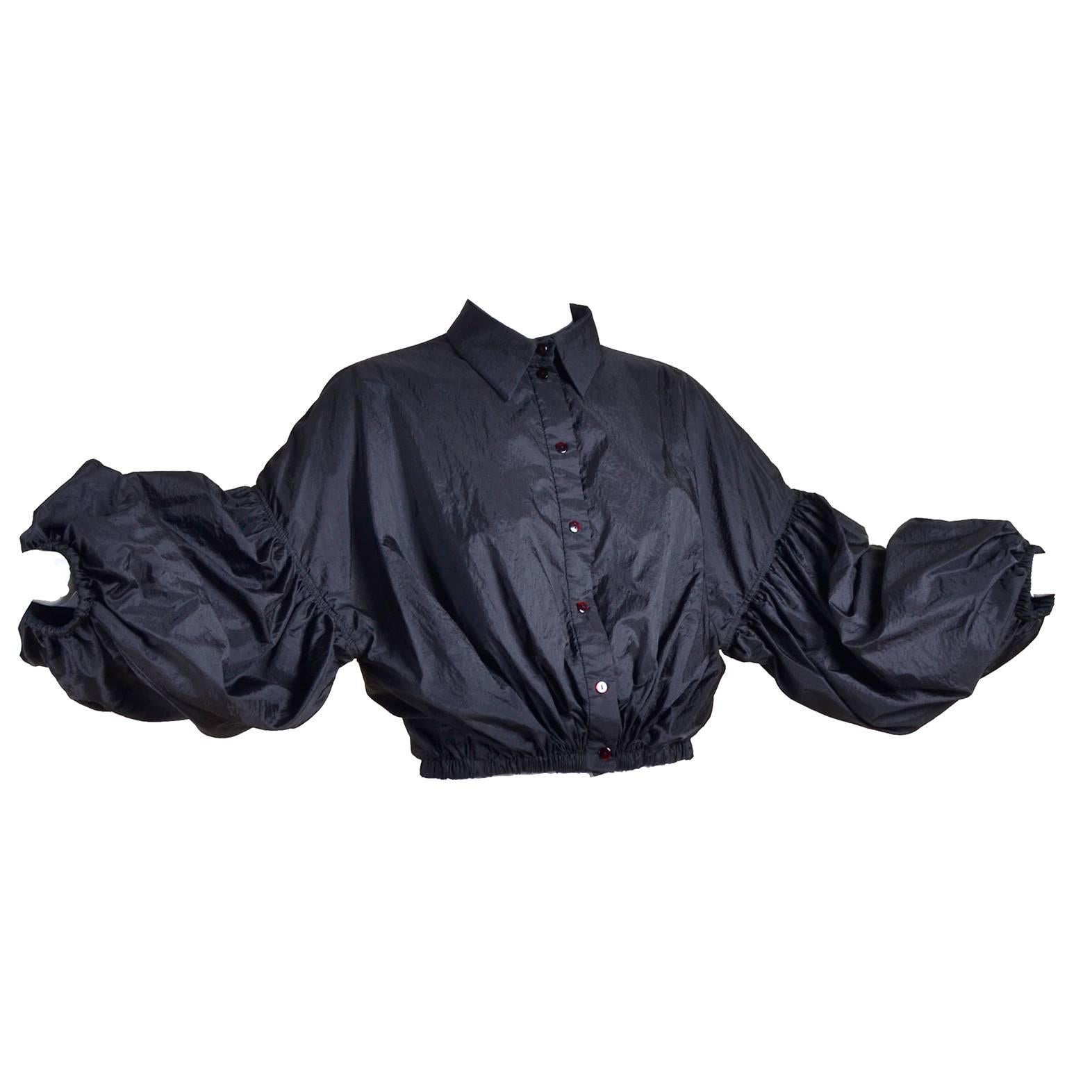 This is a dramatic cropped jacket or top from Stella McCartney that snaps up the front and has dramatic sleeves that are off shoulder and puffy.  We love the way this jacket fits a variety of sizes and the way it can be dressed up or down, depending